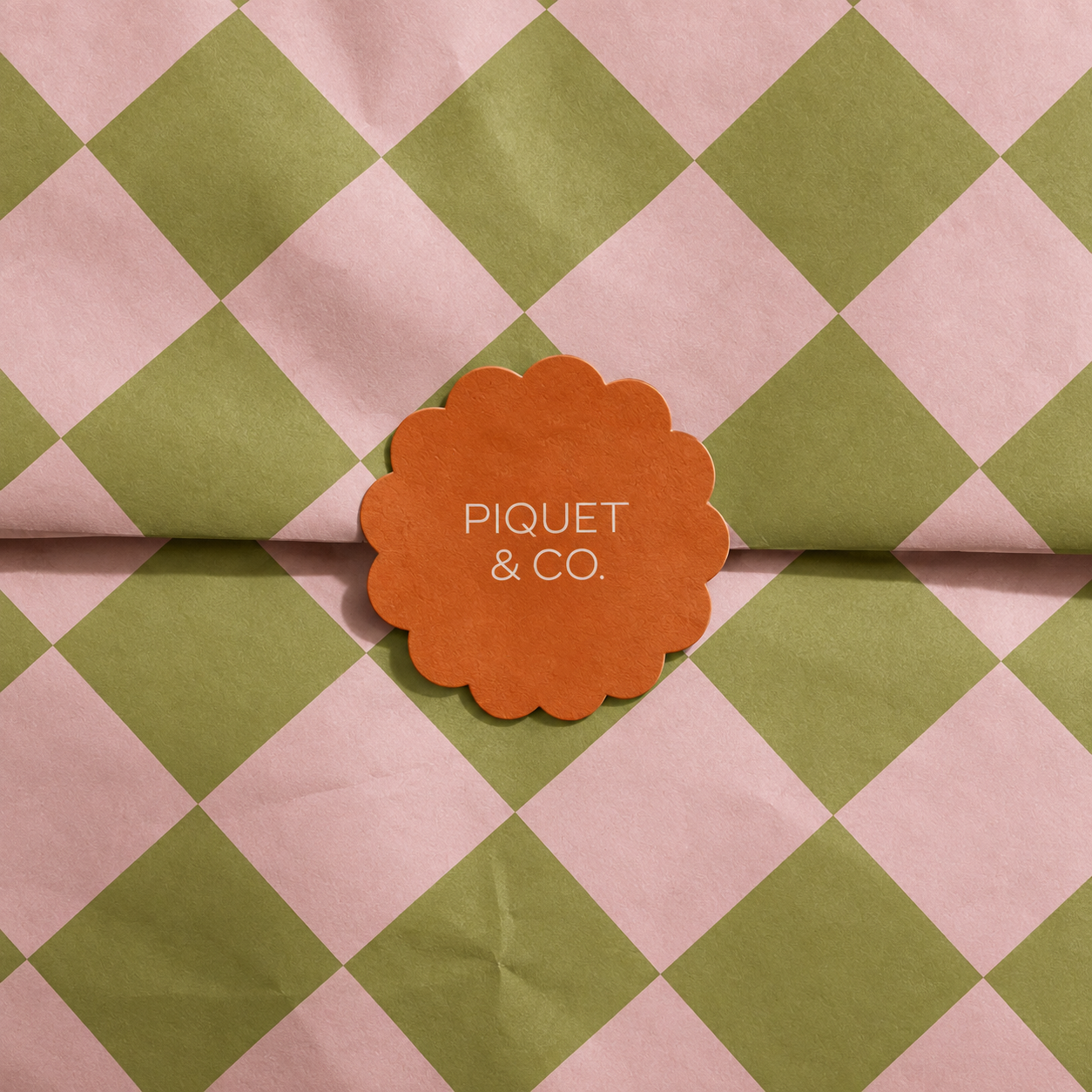 Piquet & Co. geometric pink and olive packaging with orange scalloped logo seal