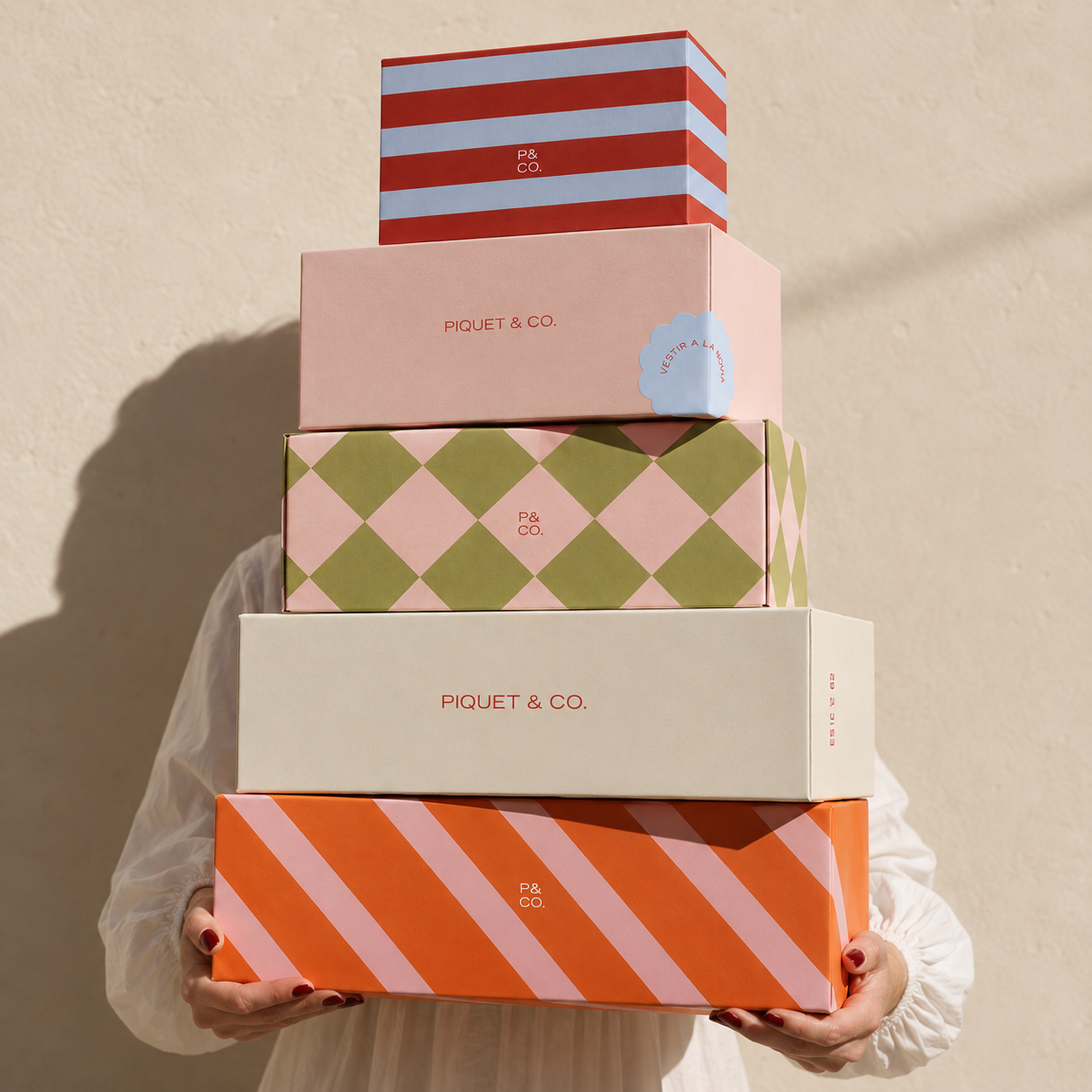 Piquet & Co. pre-made brand identity applied to colorful branded packaging and boxes