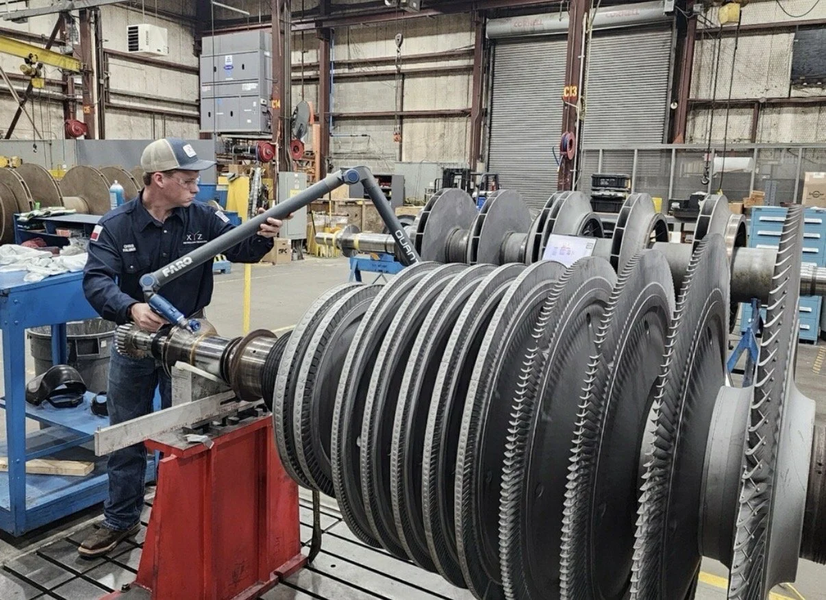 XYZ Metrology technician inspecting a large turbine rotor