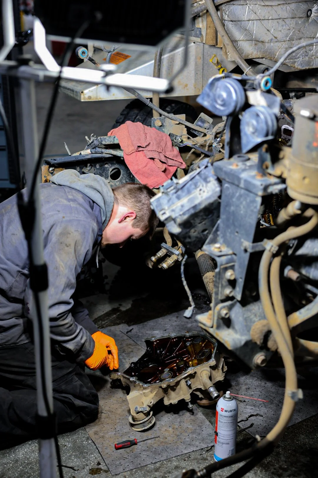 Mechanic performing engine repair at Optimus Group fleet service shop in Walker, MI.