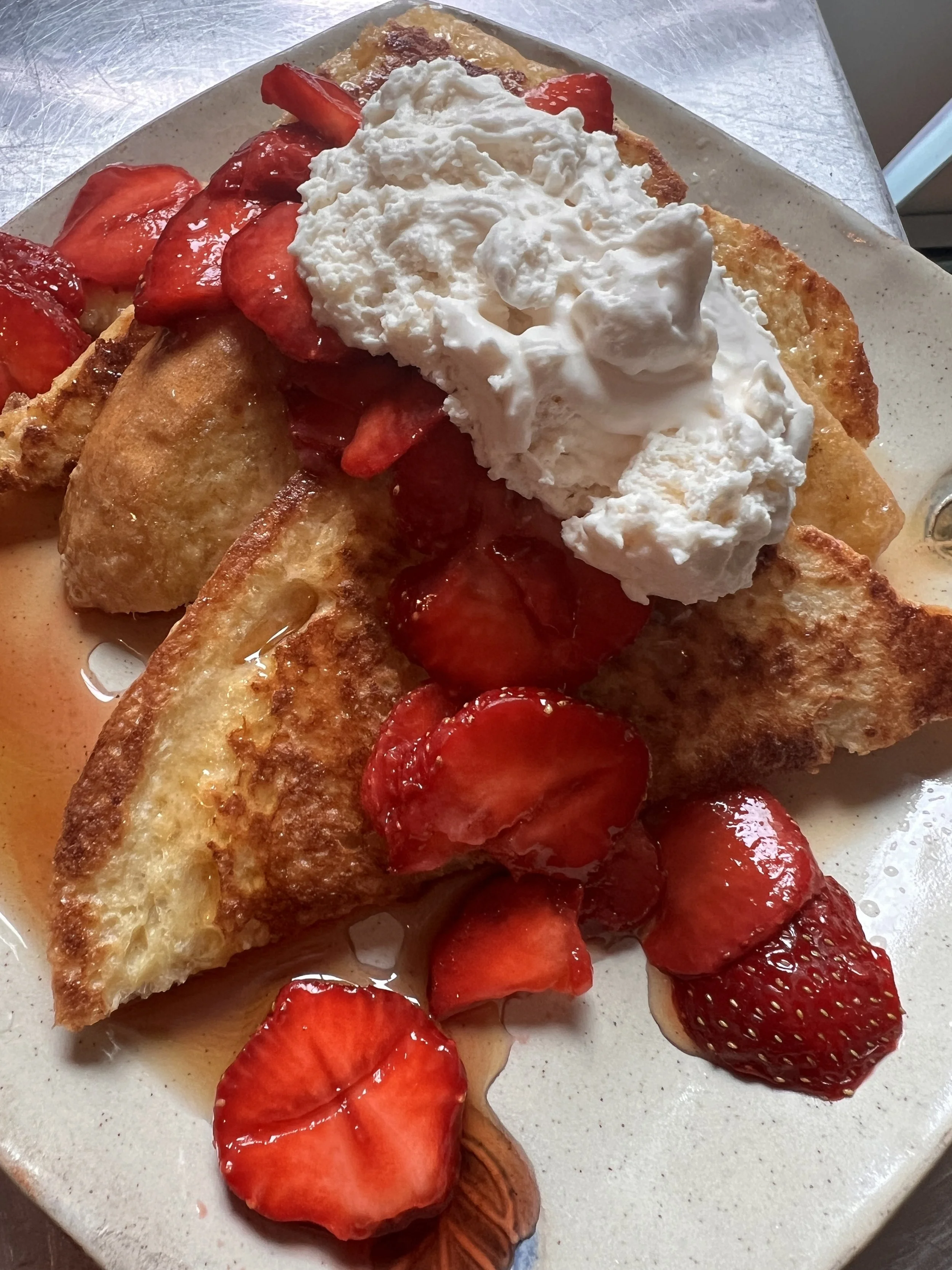 strawberry french toast drizzled with maple syrup