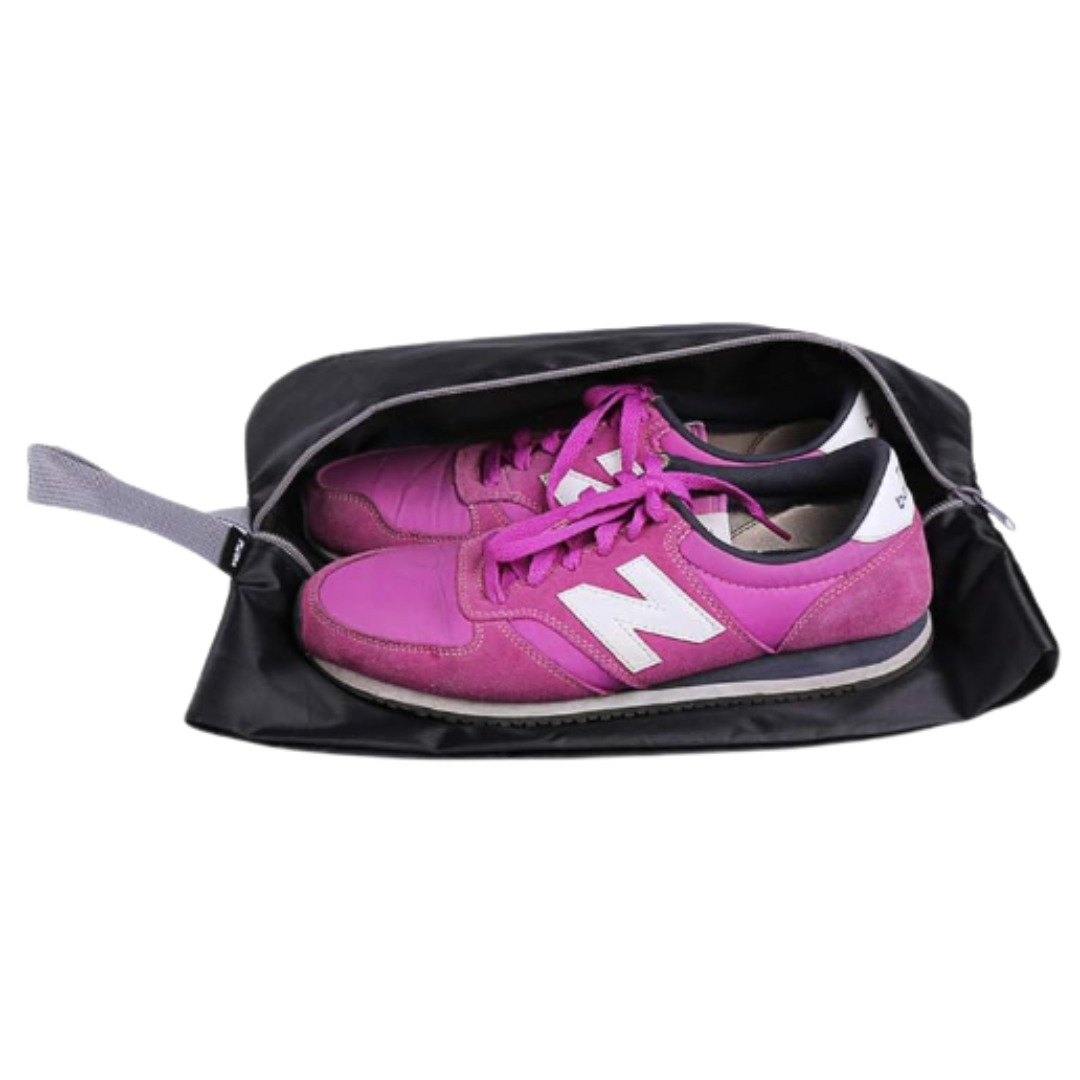 Pink and purple New Balance sneakers inside a black gym bag.