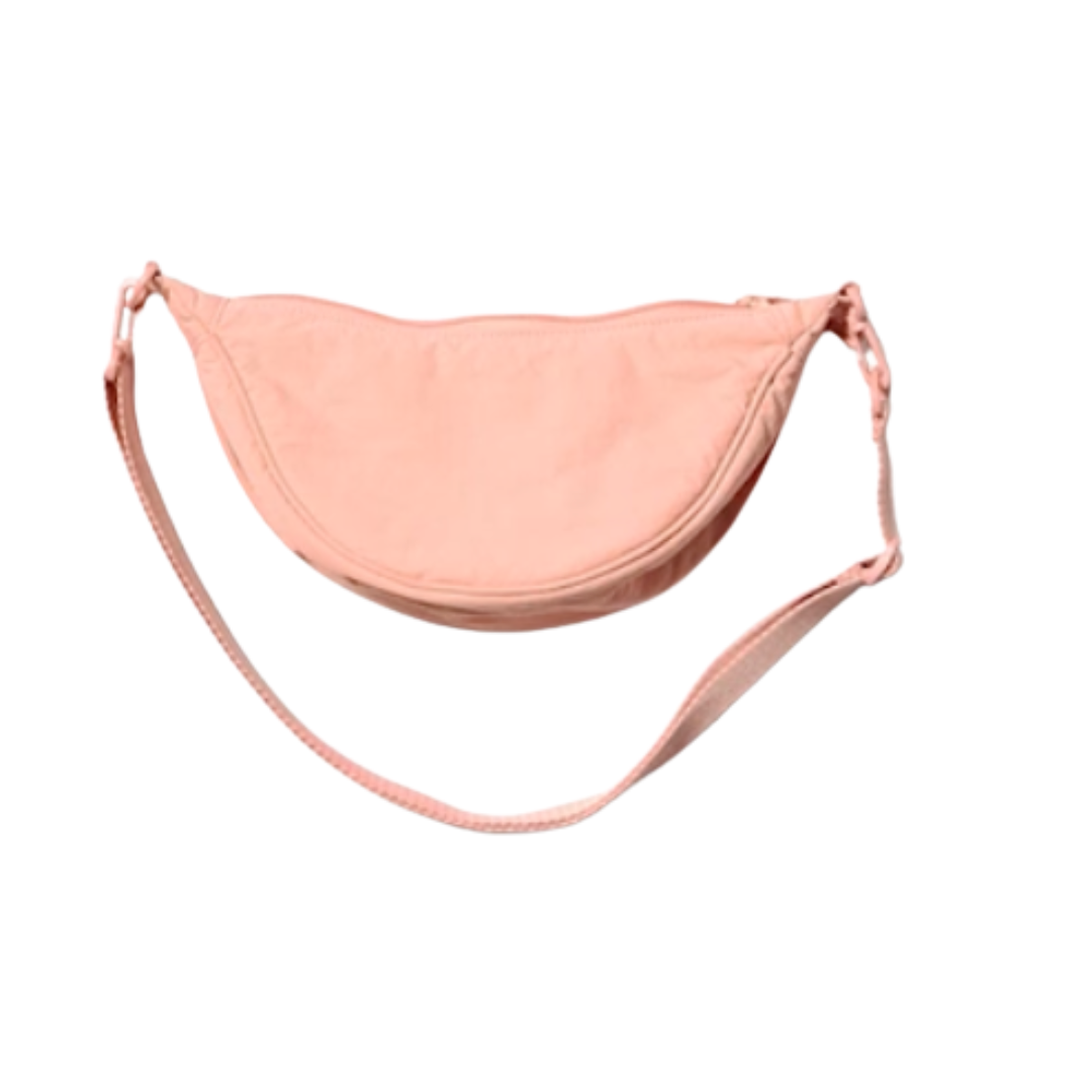 Pink sling bag with adjustable strap on a white background.