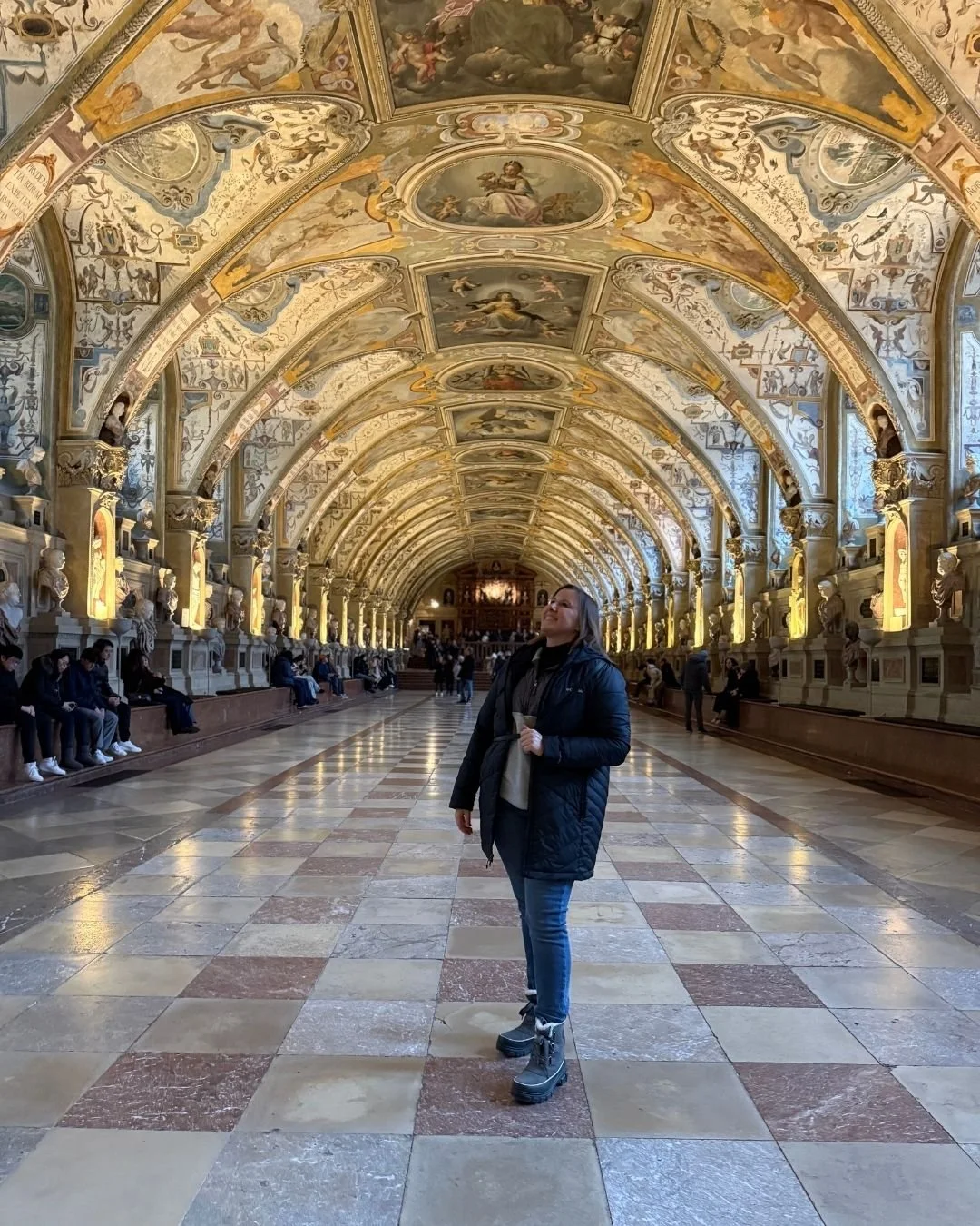 Katie Rockey looking up at the ornate ceiling in the Munich Residence in Munich, Germany