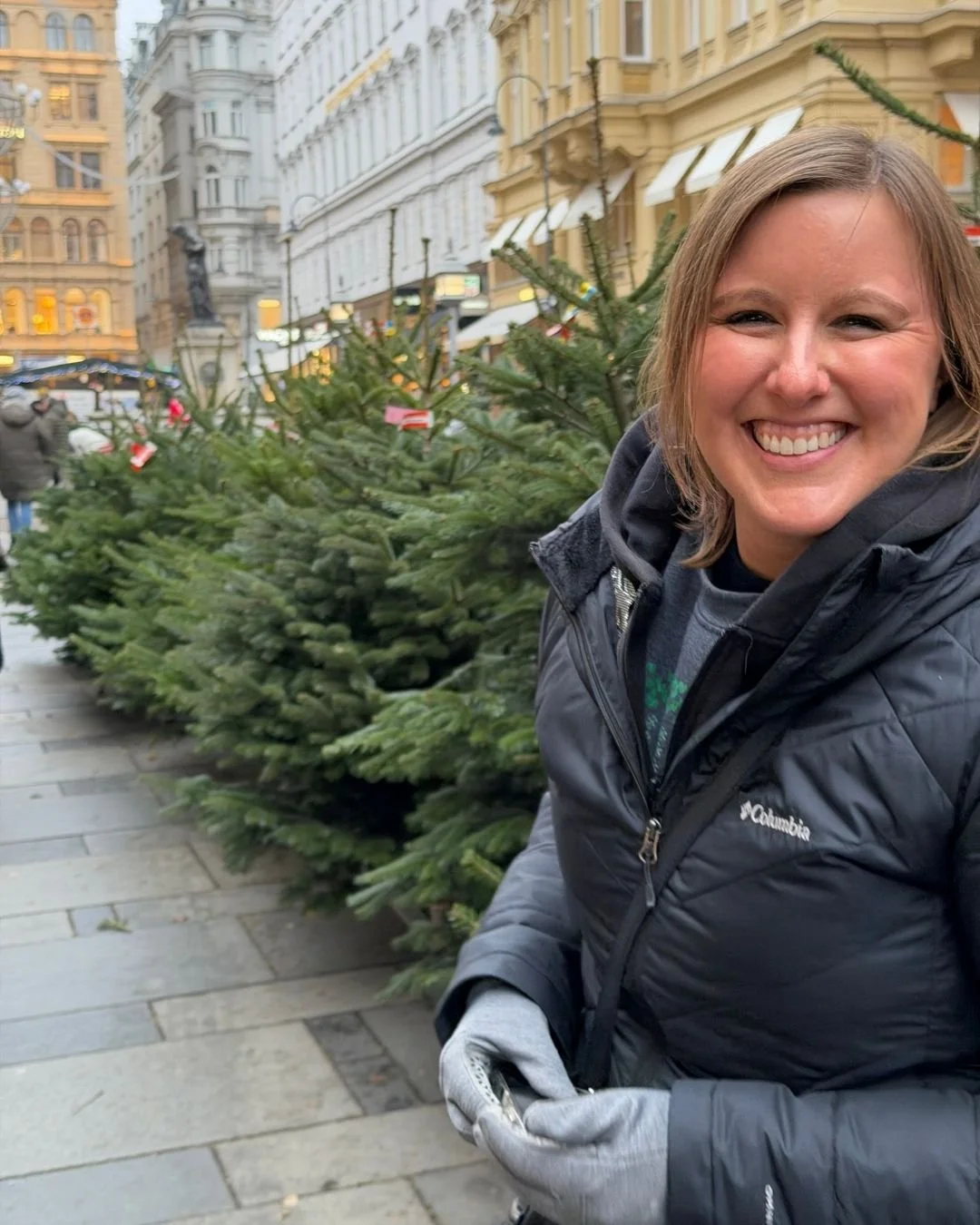 Katie Rockey laughing by trees in Vienna, Austria