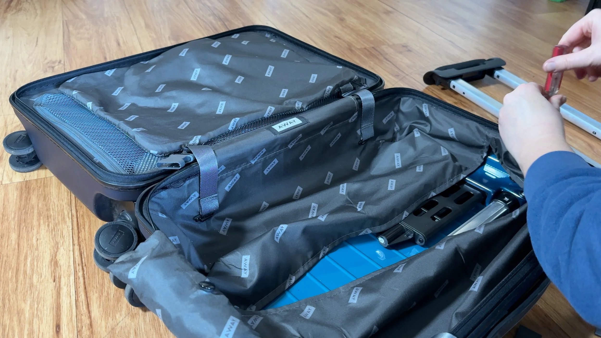 Away Bigger Carry-On Suitcase opened replacing trolley handle