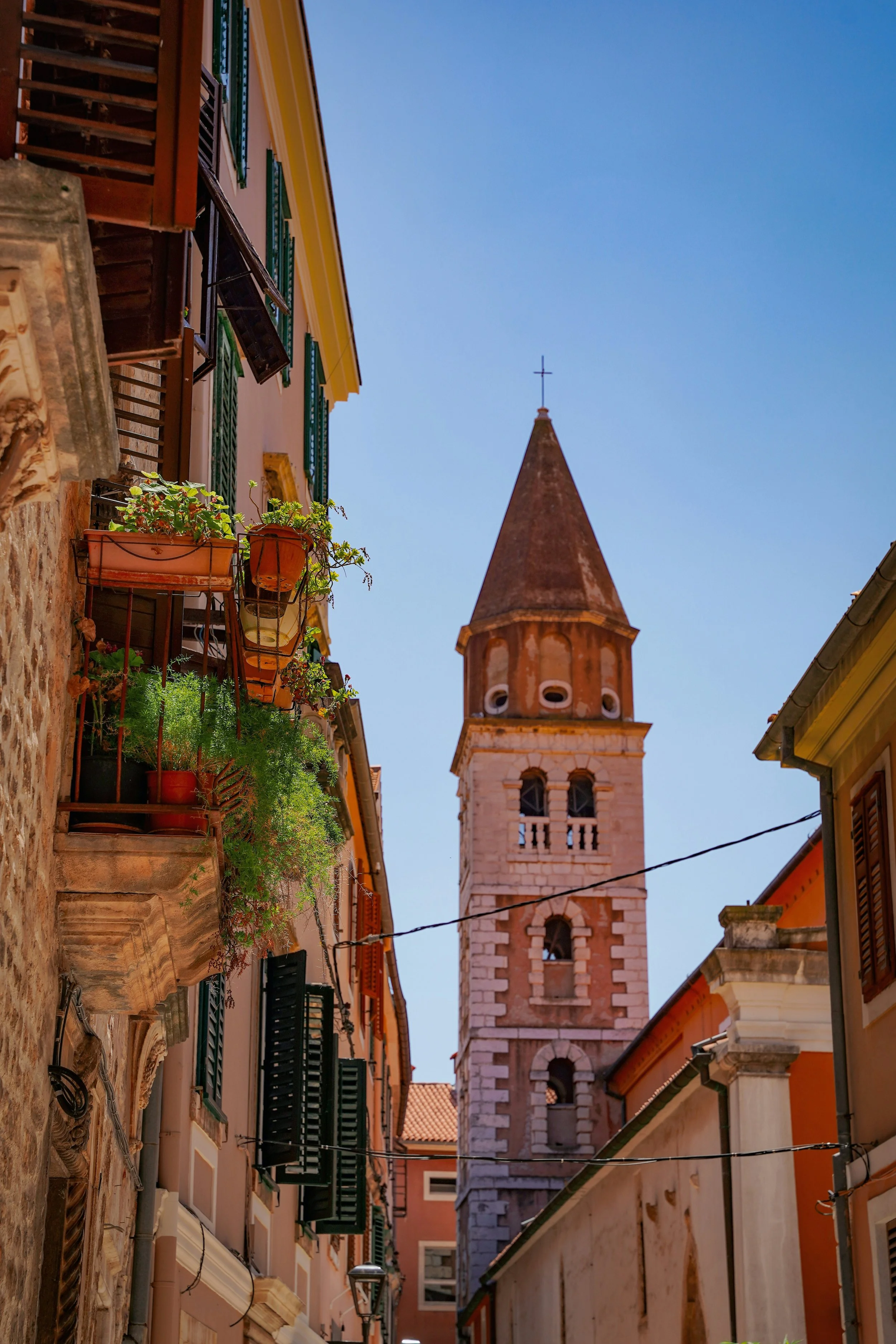 Zadar Cathedral of St. Anastasia bell tower rising above a narrow historic street in Zadar’s Old Town, Croatia.