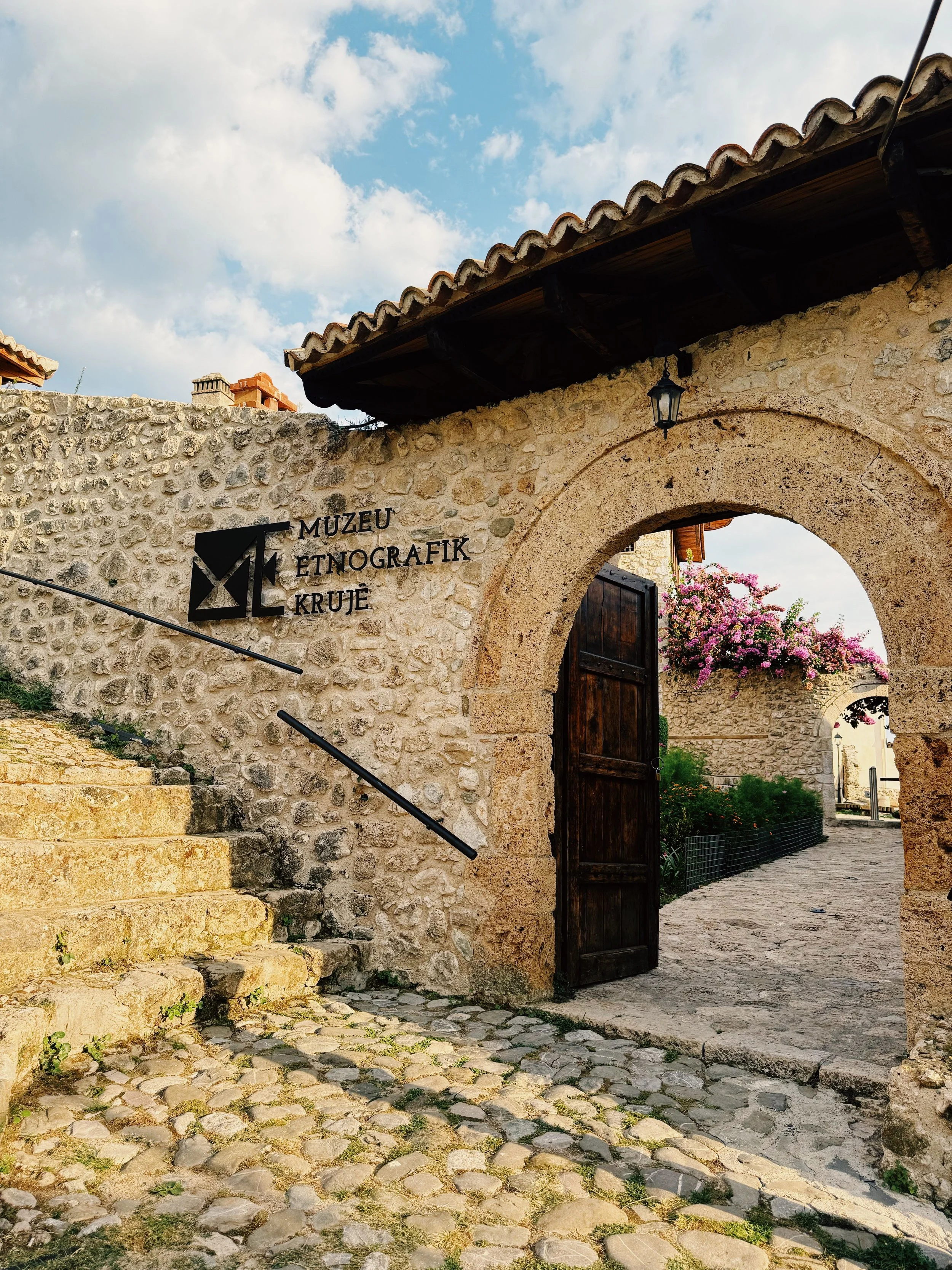 Krujë’s Ethnographic Museum in Albania, featuring a traditional stone entrance and historic architecture.