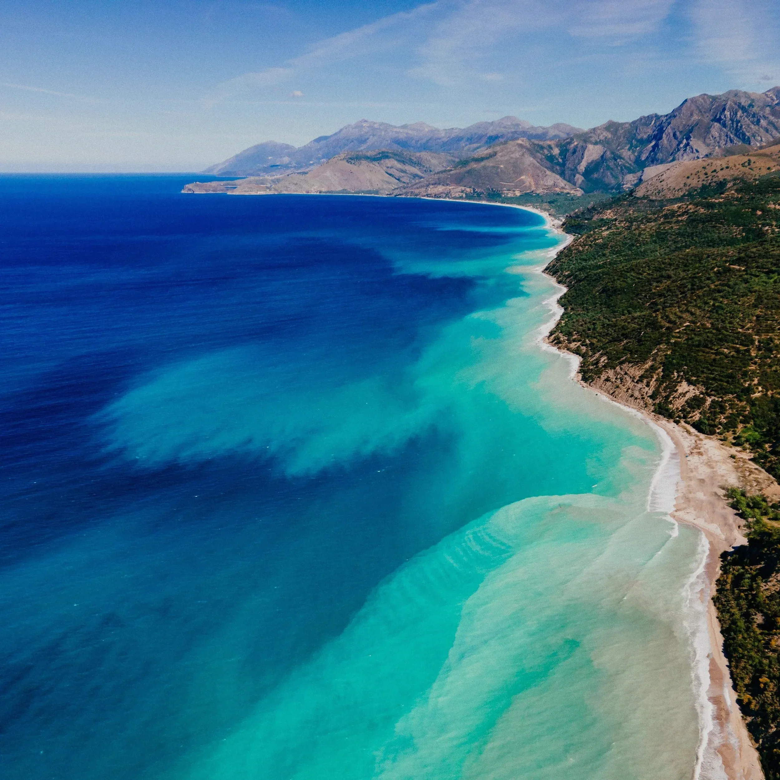 The Albanian Riviera along the Ionian Sea, known for crystal-clear waters, secluded beaches, charming coastal villages, and dramatic coastal landscapes.
