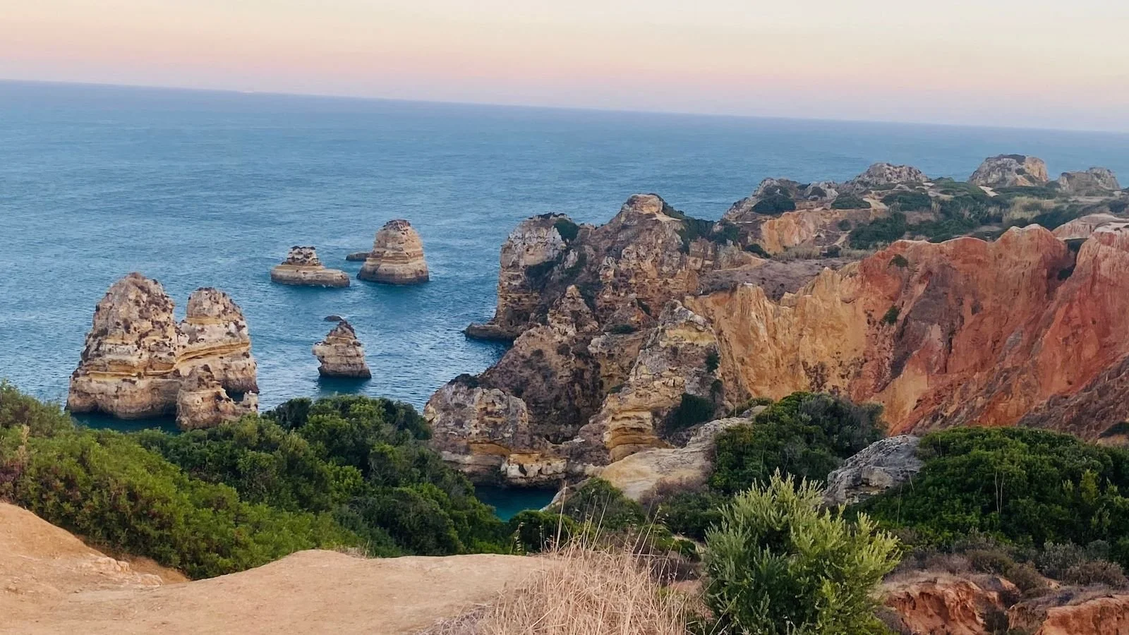 Ponta da Piedade in Lagos, Algarve, Portugal, featuring golden limestone cliffs and striking sea stacks.