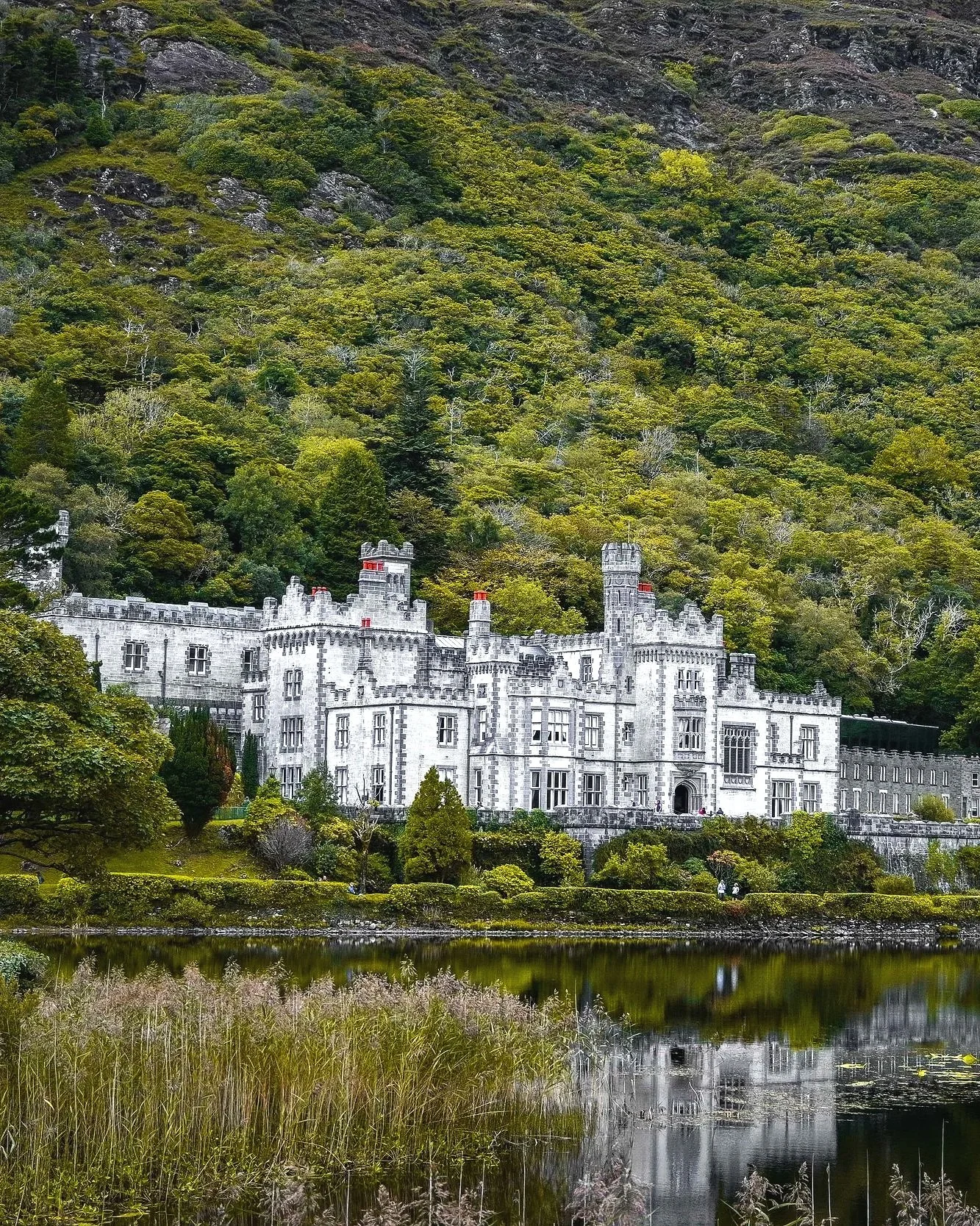 Kylemore Abbey in Connemara, County Galway, Ireland, a historic Gothic Revival landmark set beside a tranquil lake and surrounded by scenic mountains.