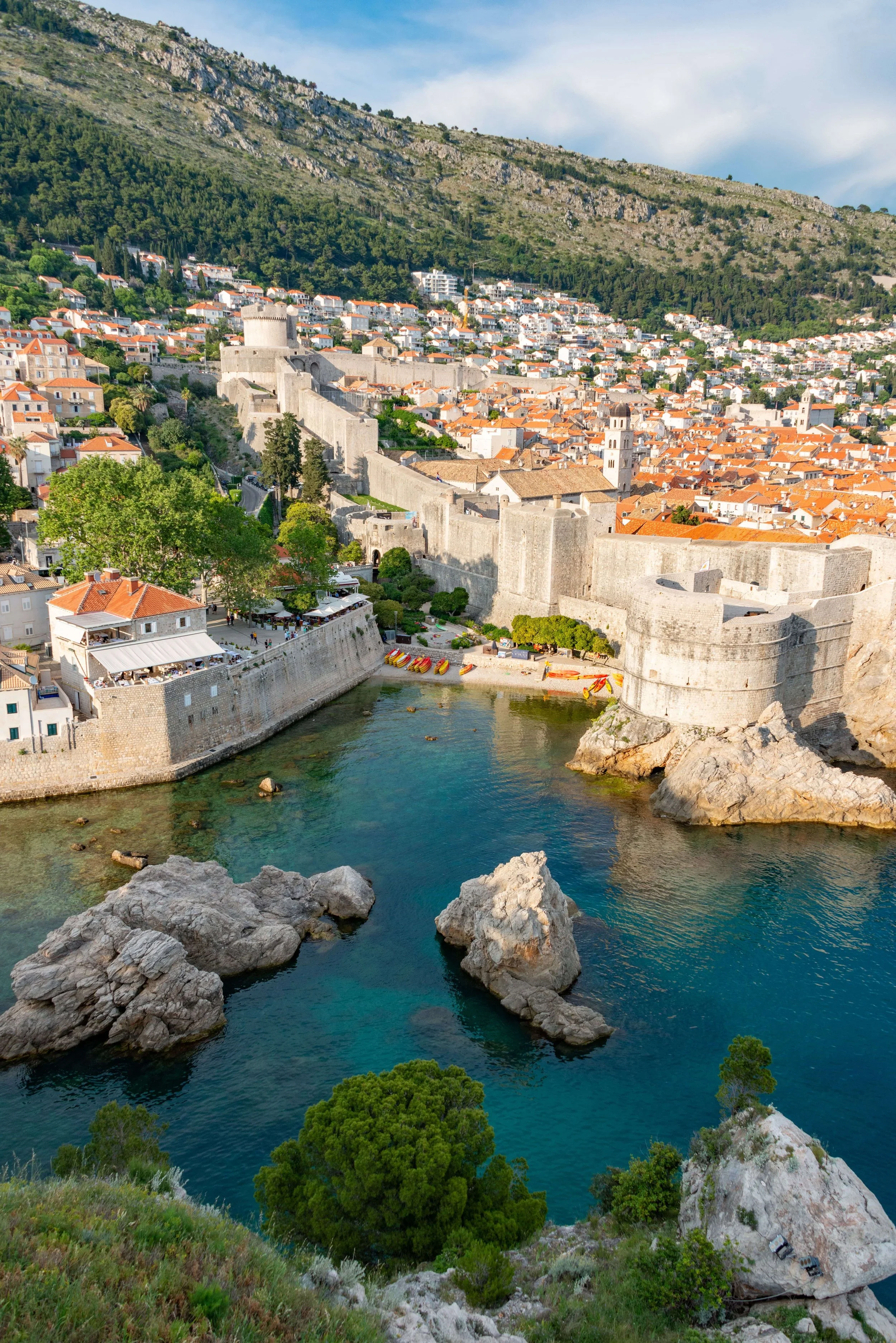 Dubrovnik’s Old Town, featuring medieval stone walls, West Harbour, and Fort Lovrijenac overlooking the Adriatic coast.