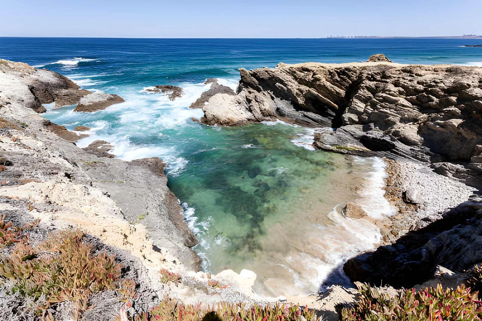 Secluded cove along the Fishermen’s Trail in Southwest Alentejo, Portugal, with turquoise waters and rugged cliffs.