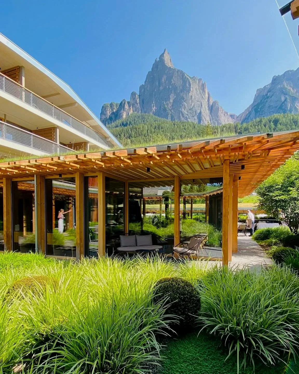 Sensoria Dolomites in Siusi allo Sciliar, South Tyrol, Italy, featuring elegant architecture and landscaped gardens beneath the dramatic peaks of Mount Sciliar.