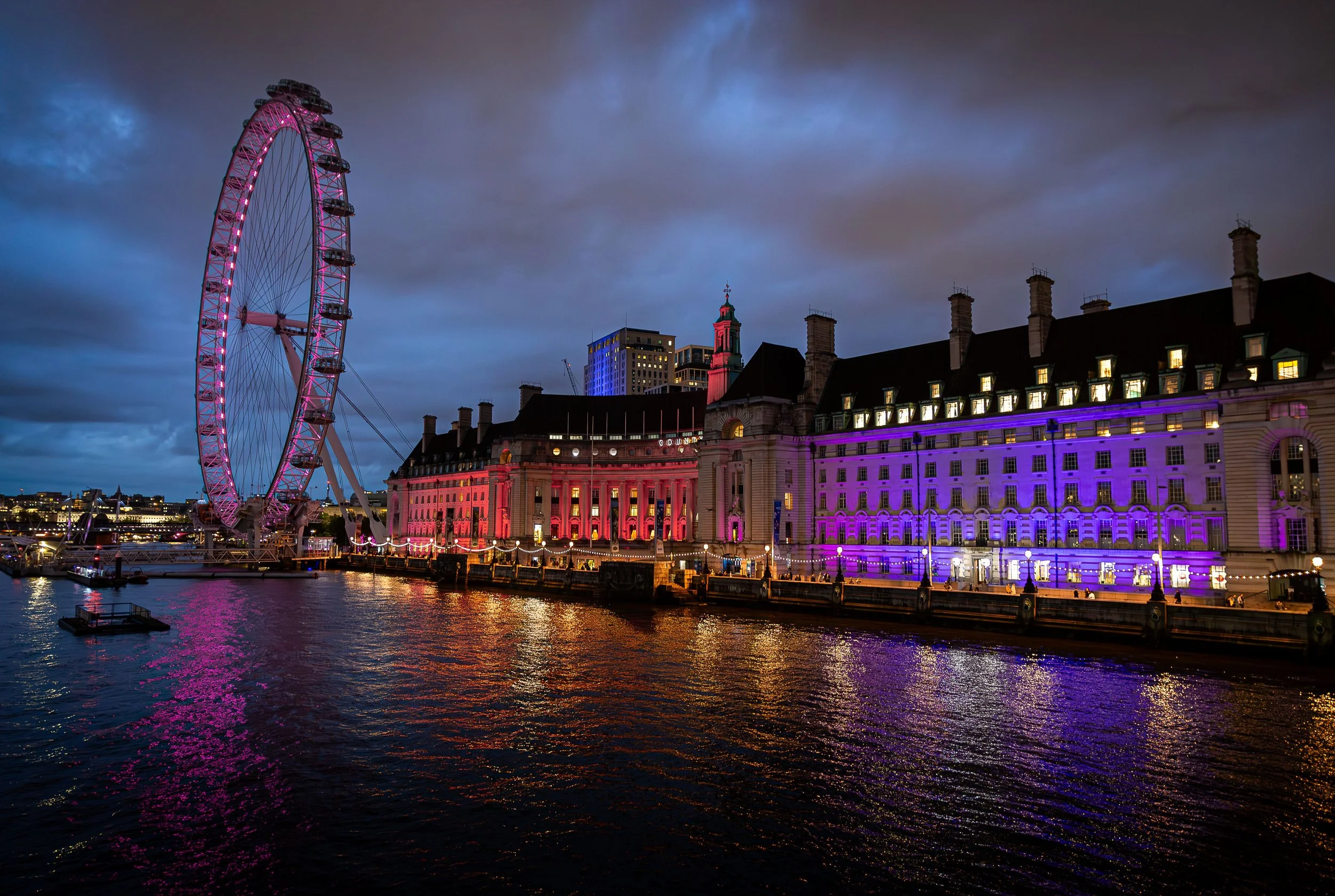 London Eye and festive Christmas market lights illuminating the River Thames in London, England