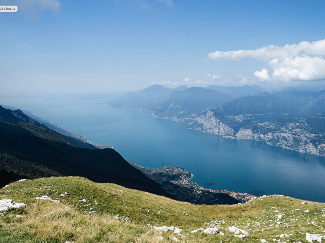 Monte Baldo, northern Italy, offering panoramic views of Lake Garda and the historic town of Malcesine along its eastern shore.