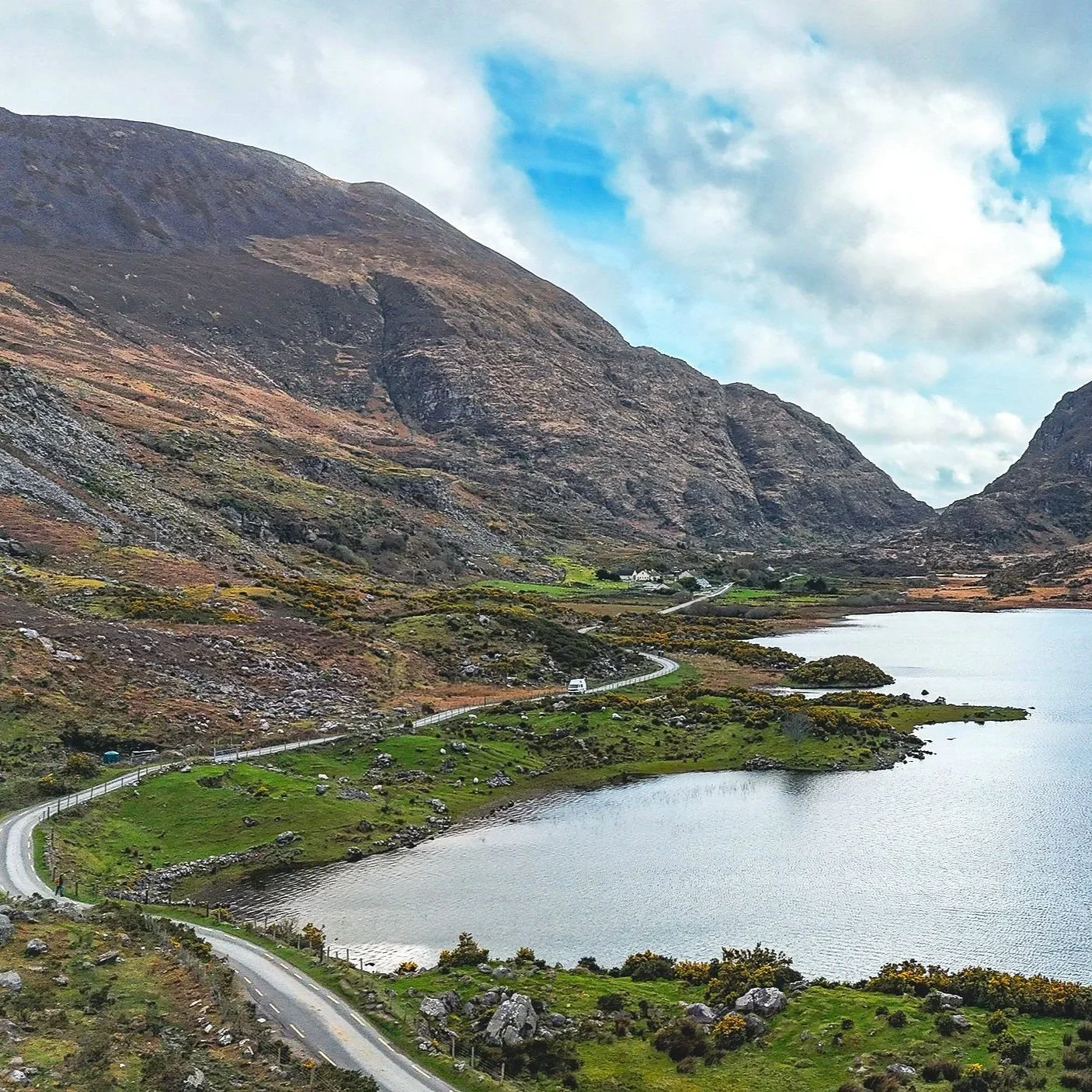 The Gap of Dunloe in County Kerry, Ireland, a dramatic mountain pass surrounded by rugged peaks, lush valleys, and scenic countryside.