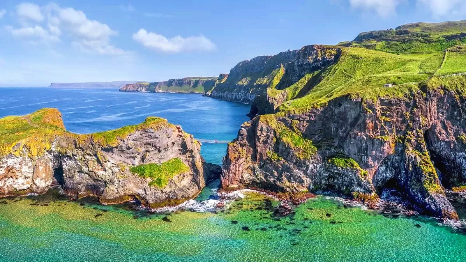 Carrick-a-Rede Rope Bridge in County Antrim, Northern Ireland, a historic suspension bridge spanning a dramatic coastal gorge above the Atlantic Ocean.