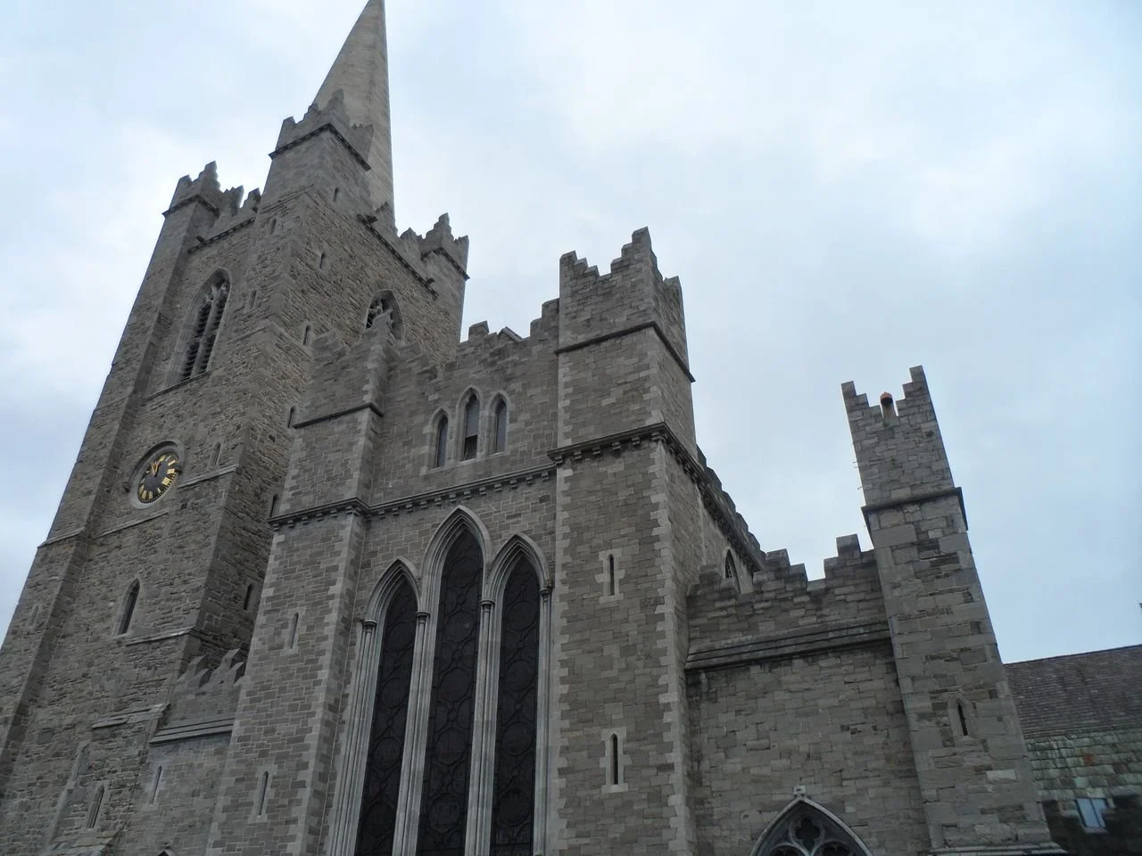 St. Patrick’s Cathedral in Dublin, Ireland, a historic medieval Gothic landmark known for its stone architecture, crenellated rooflines, and tall central spire.