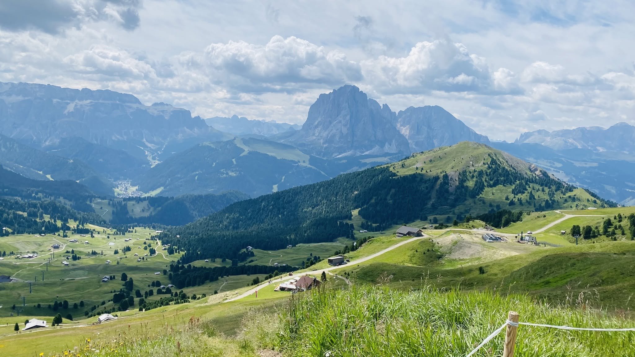 Seceda and the Sassolungo mountain group in Val Gardena, South Tyrol, Italy, featuring dramatic jagged peaks and scenic alpine landscapes.