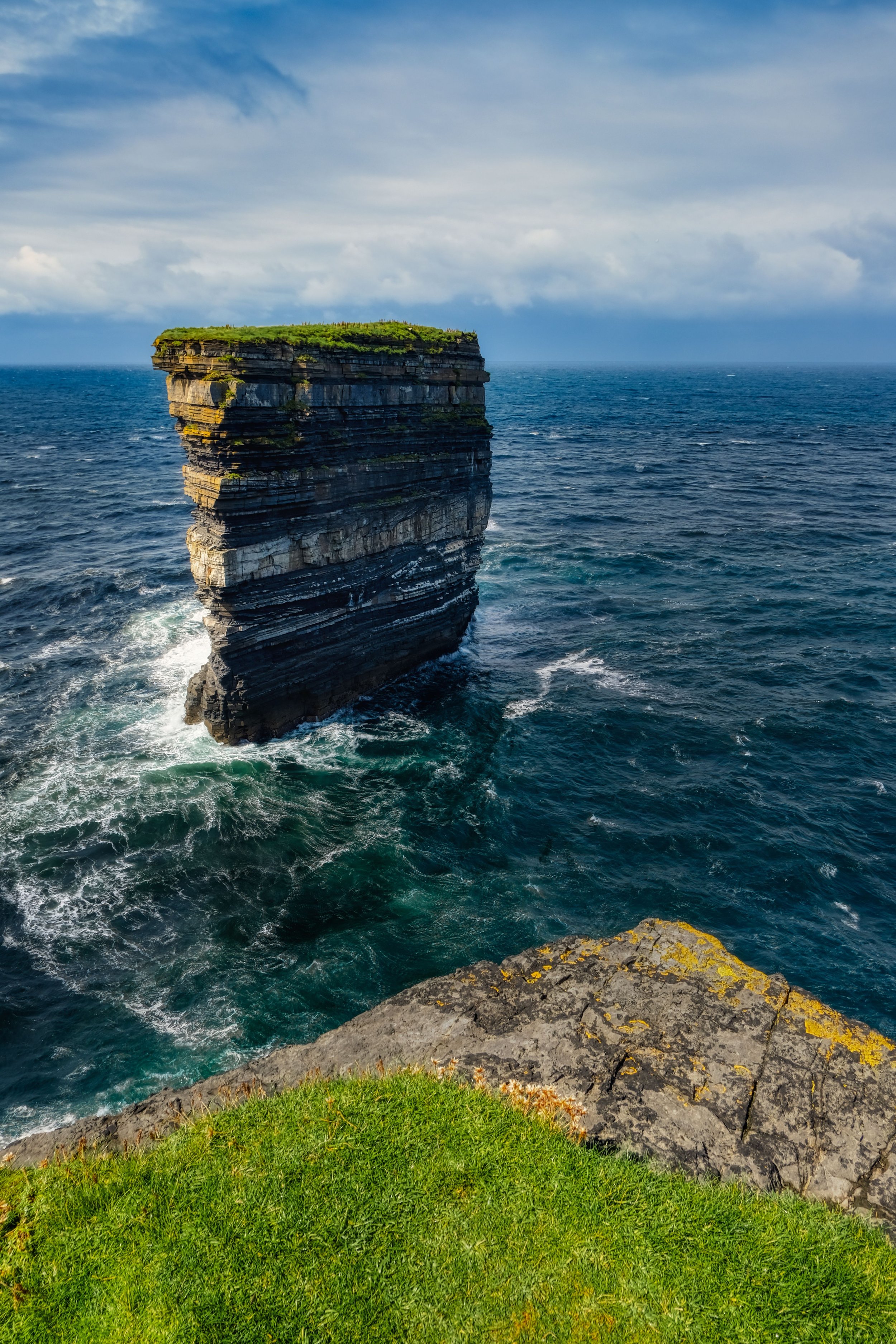 Dún Briste at Downpatrick Head, County Mayo, Ireland, a dramatic sea stack rising from the Atlantic Ocean, known for its striking layered rock formations.