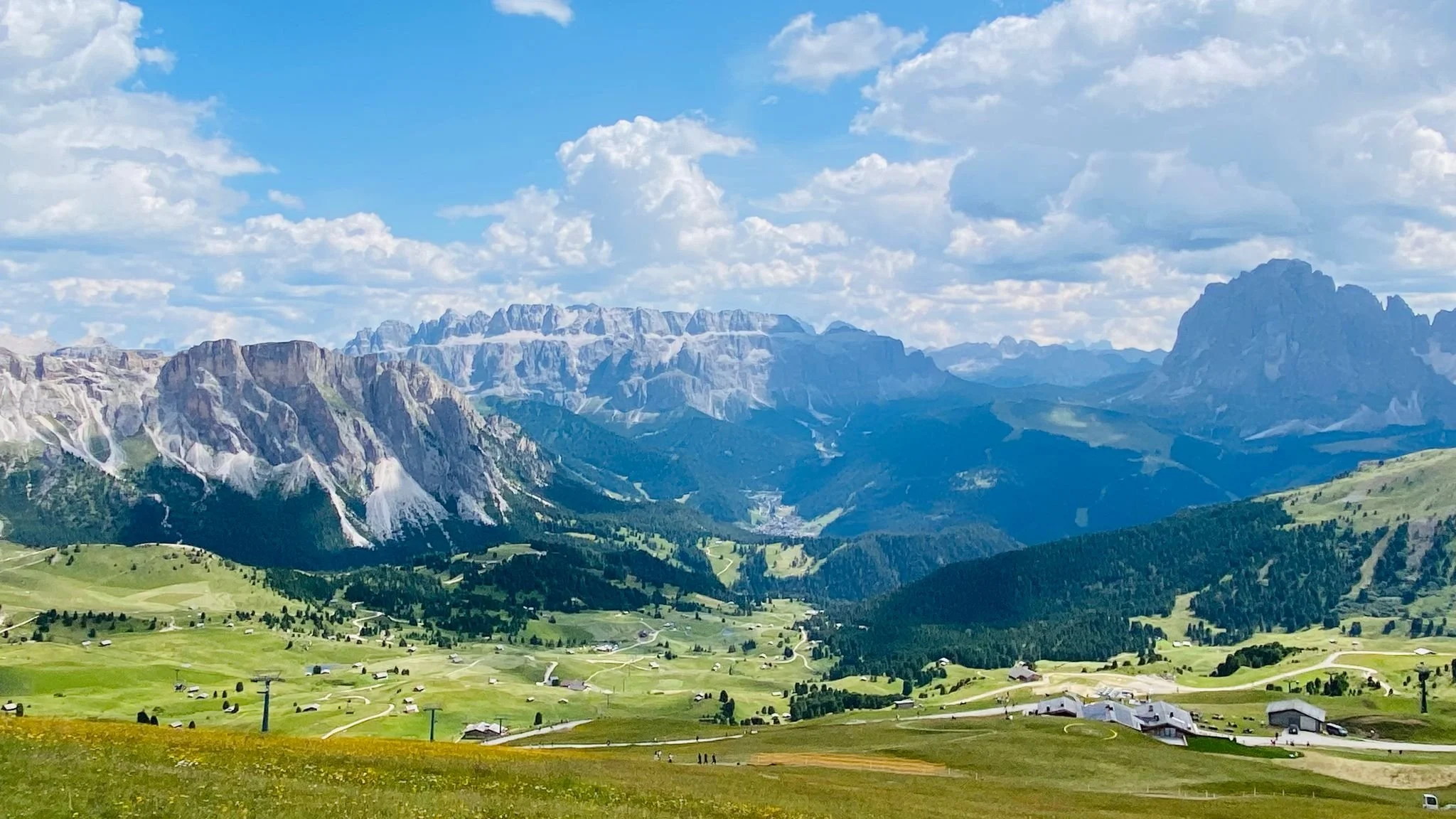 Seceda in Val Gardena, South Tyrol, Italy, featuring lush alpine meadows beneath dramatic limestone peaks, with views of the Sassolungo massif.