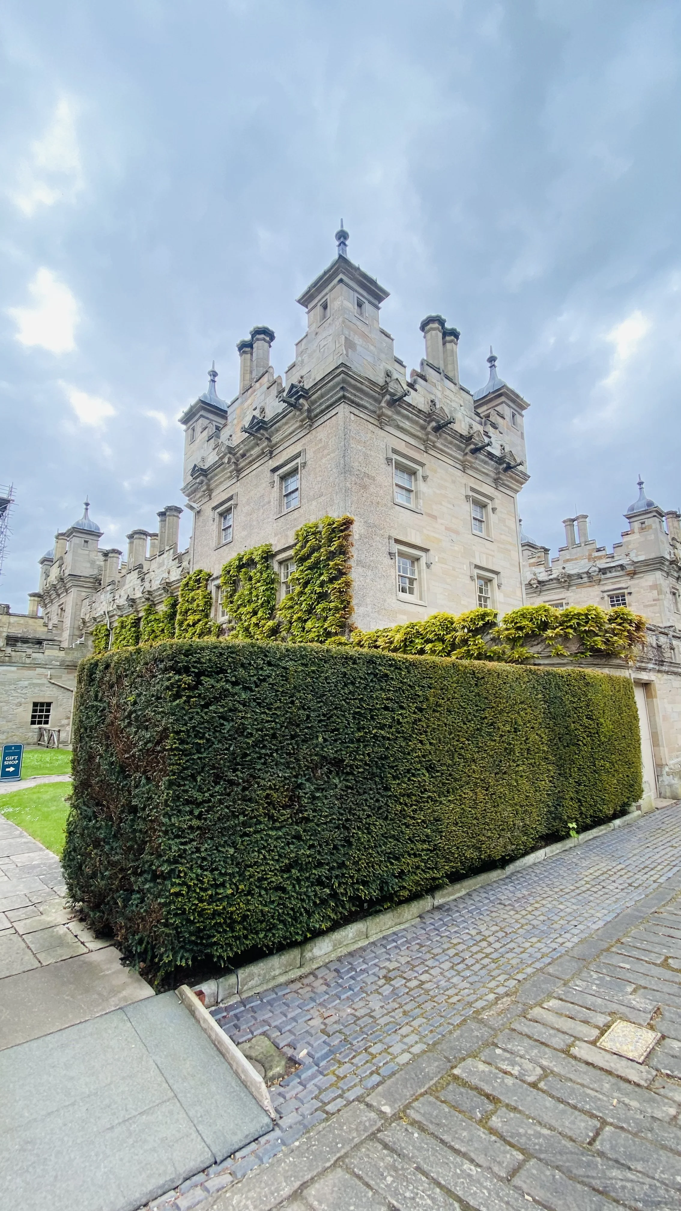 Afternoon tea setting in the walled garden of Floors Castle with castle facade behind, Kelso, Scotland