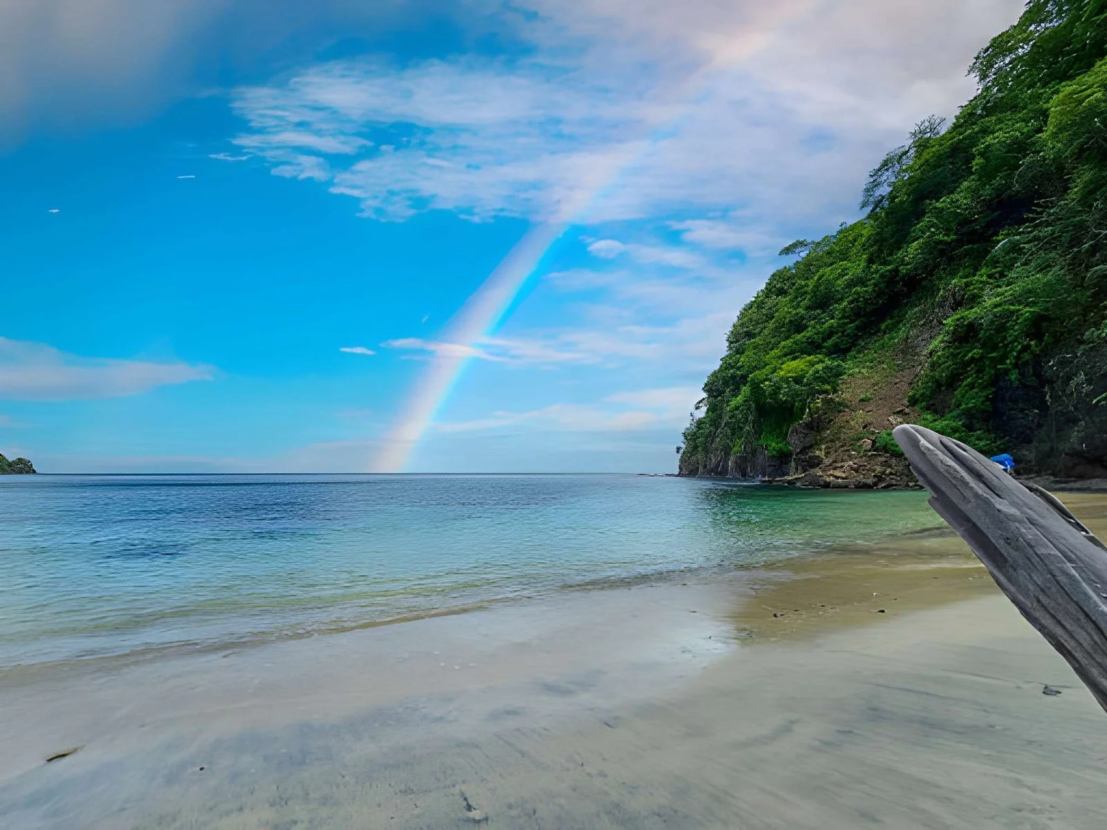Blanca Beach and the blue waters of Culebra Bay, lush green trees, blue sky and clouds in Liberia Guanacaste Costa Rica