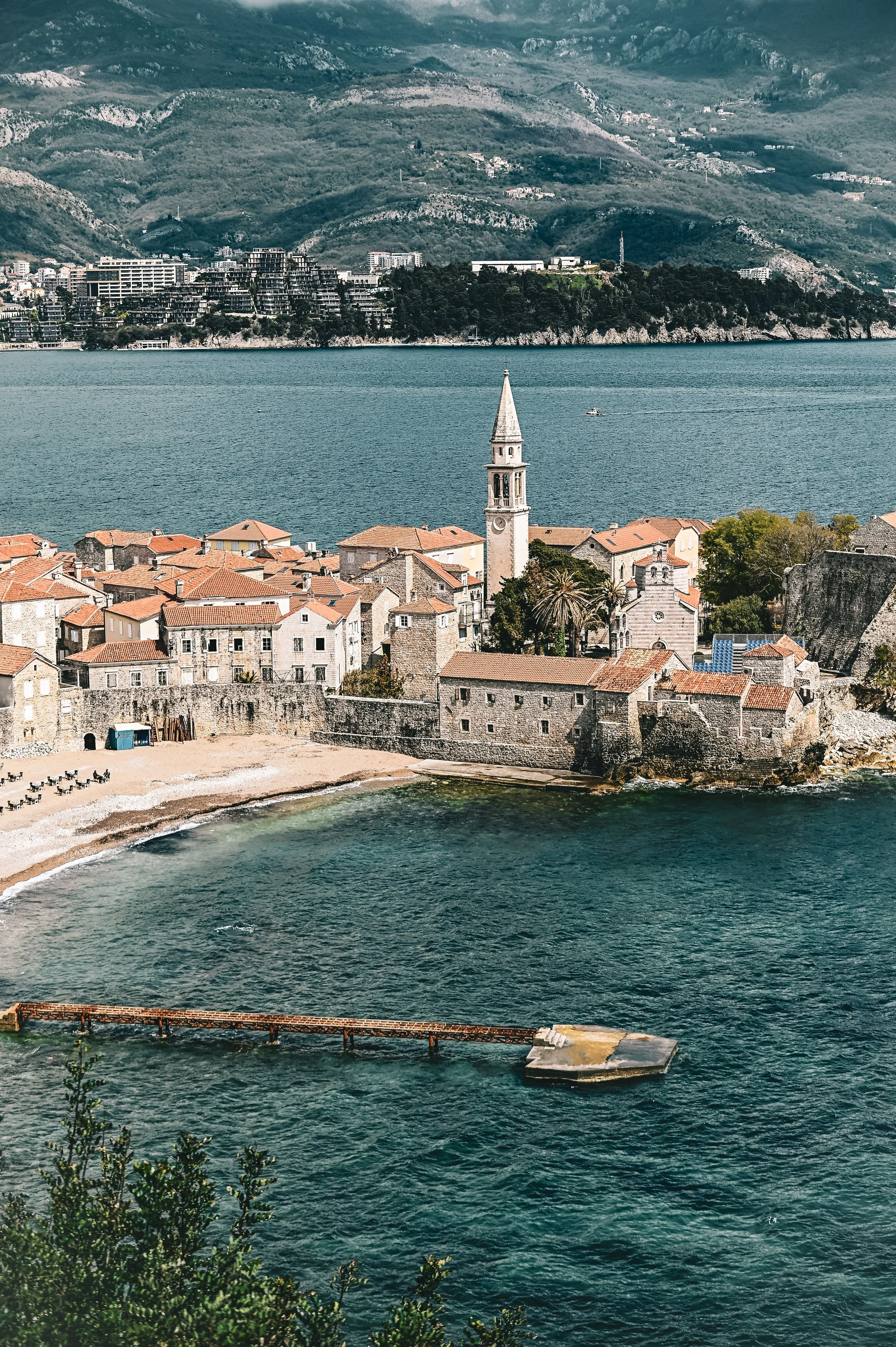 Budva, Montenegro, featuring its historic coastal town surrounded by dramatic mountains and the Adriatic Sea.