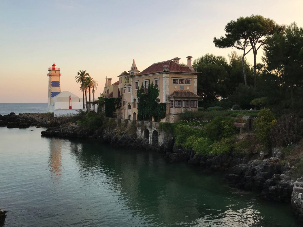 Casa de Santa Maria and Santa Marta Lighthouse on the rocky coast of Cascais, Portugal.
