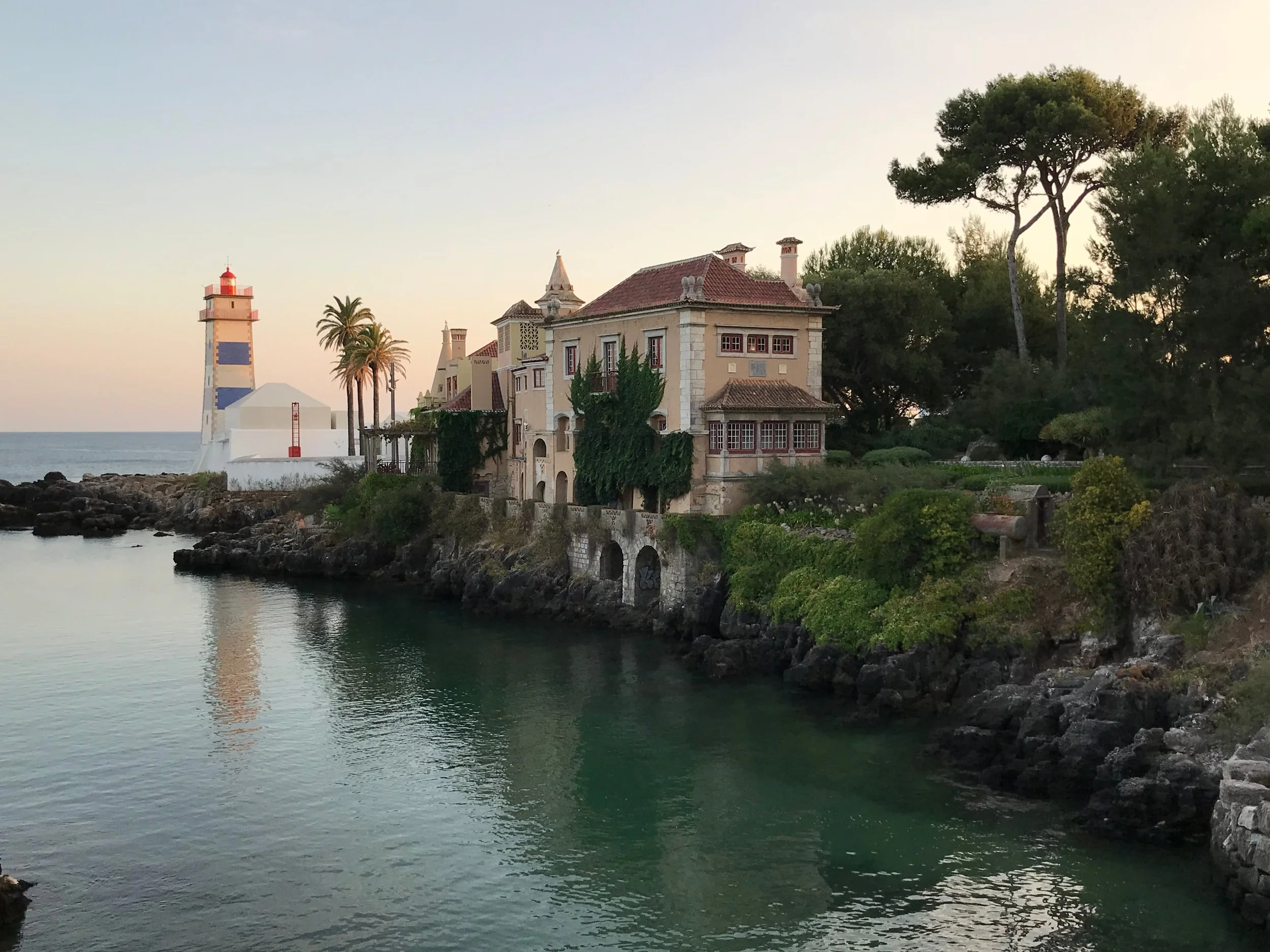 Santa Marta Lighthouse and Casa de Santa Maria on the coast of Cascais, Portugal.