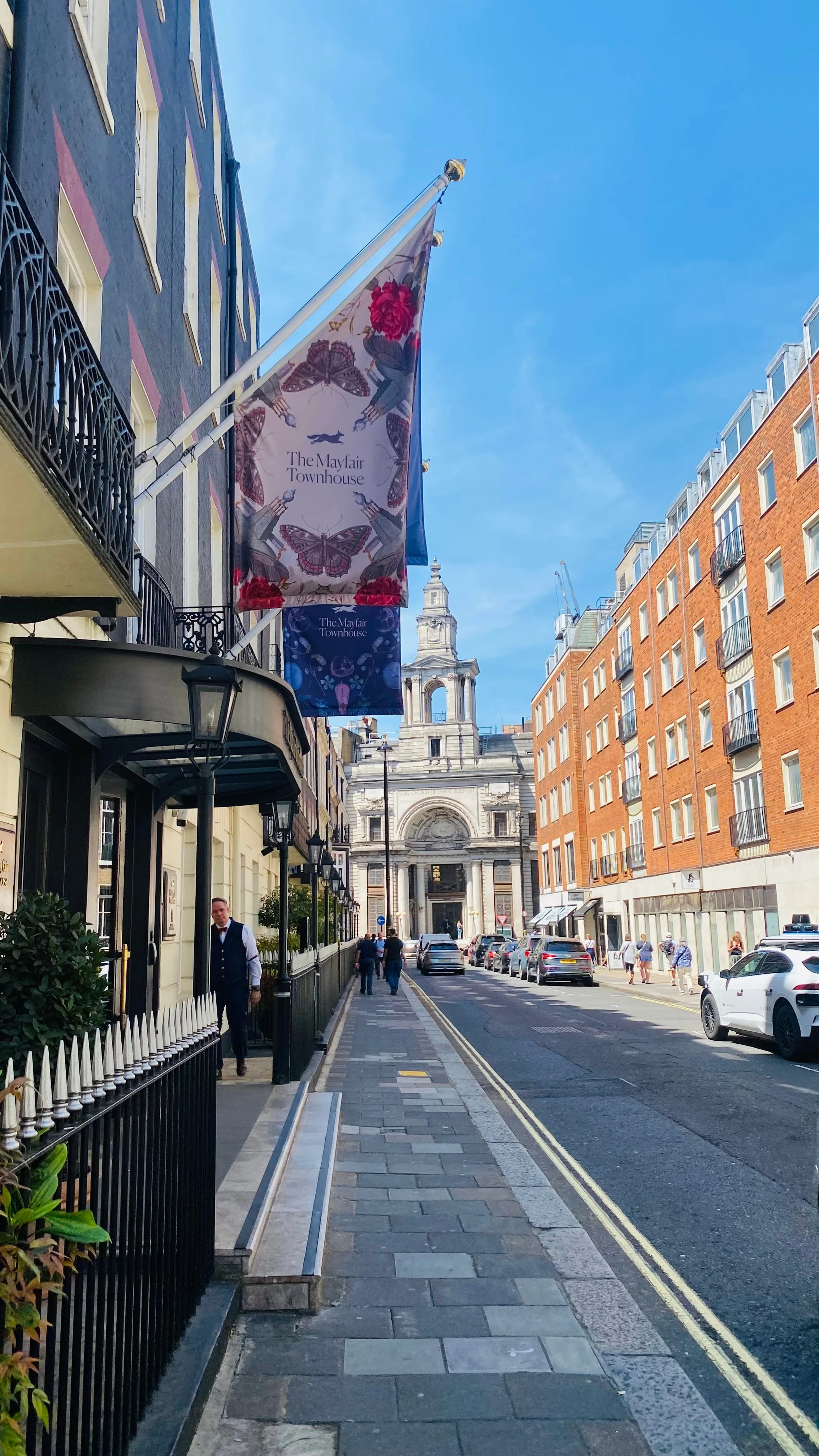 Early morning light on a central London street of white stucco townhouses and black railings, England