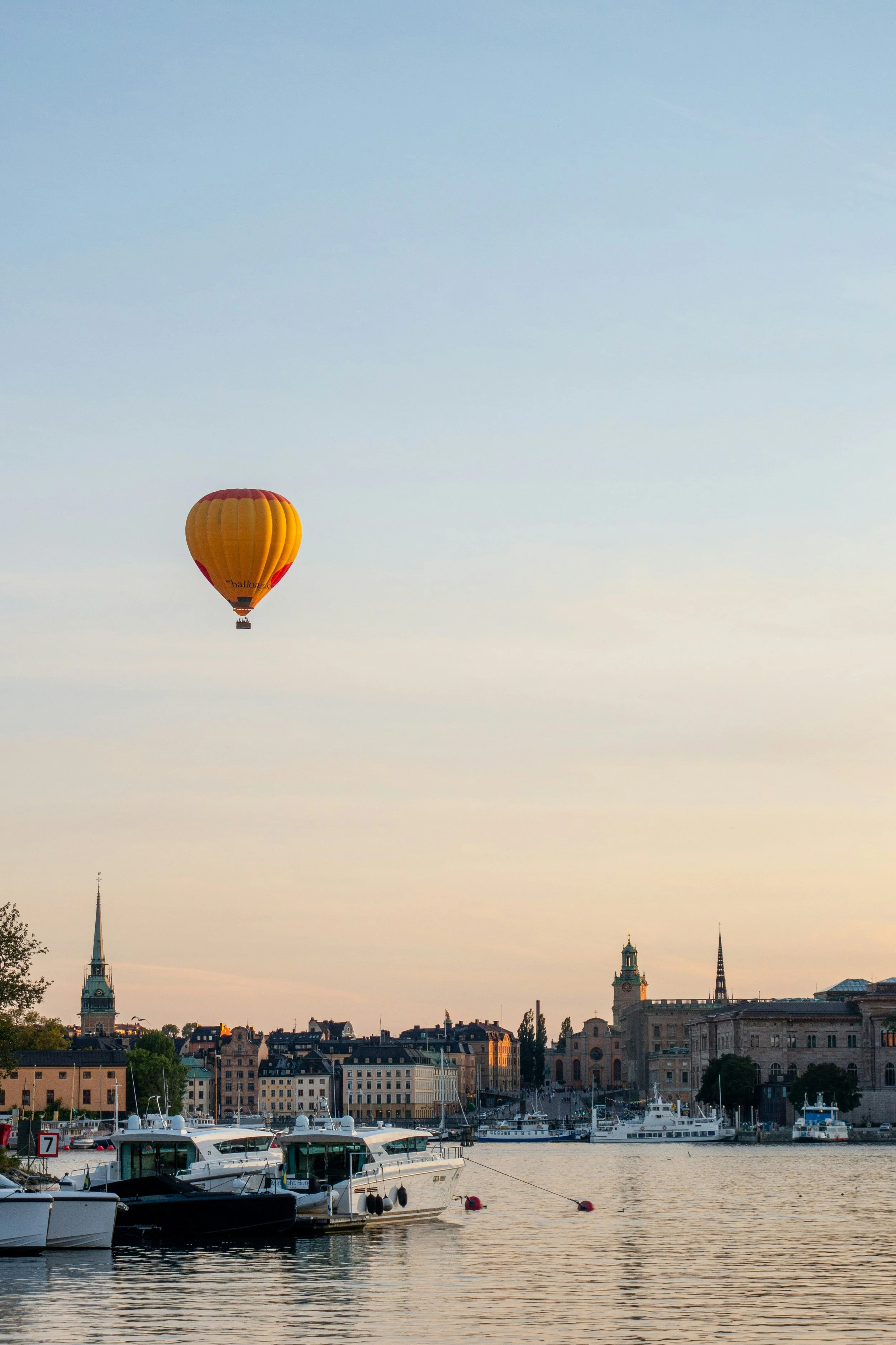 Hot air balloon over the city at golden hour, Stockholm, Sweden