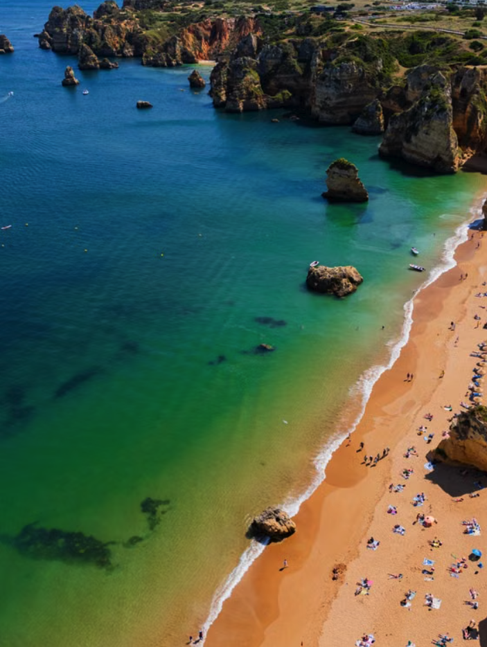 Praia Dona Ana, a scenic beach with golden cliffs and turquoise waters in Lagos, Portugal.