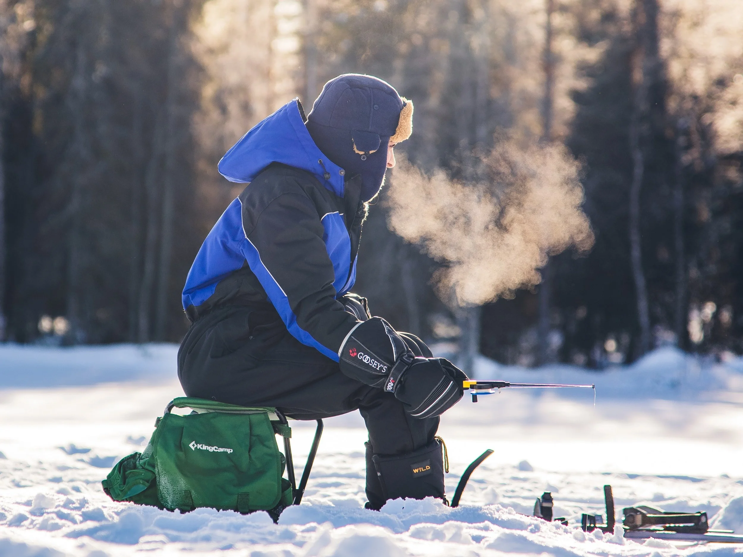 Family on snowmobiles crossing a frozen Lapland lake, Rovaniemi, Finland