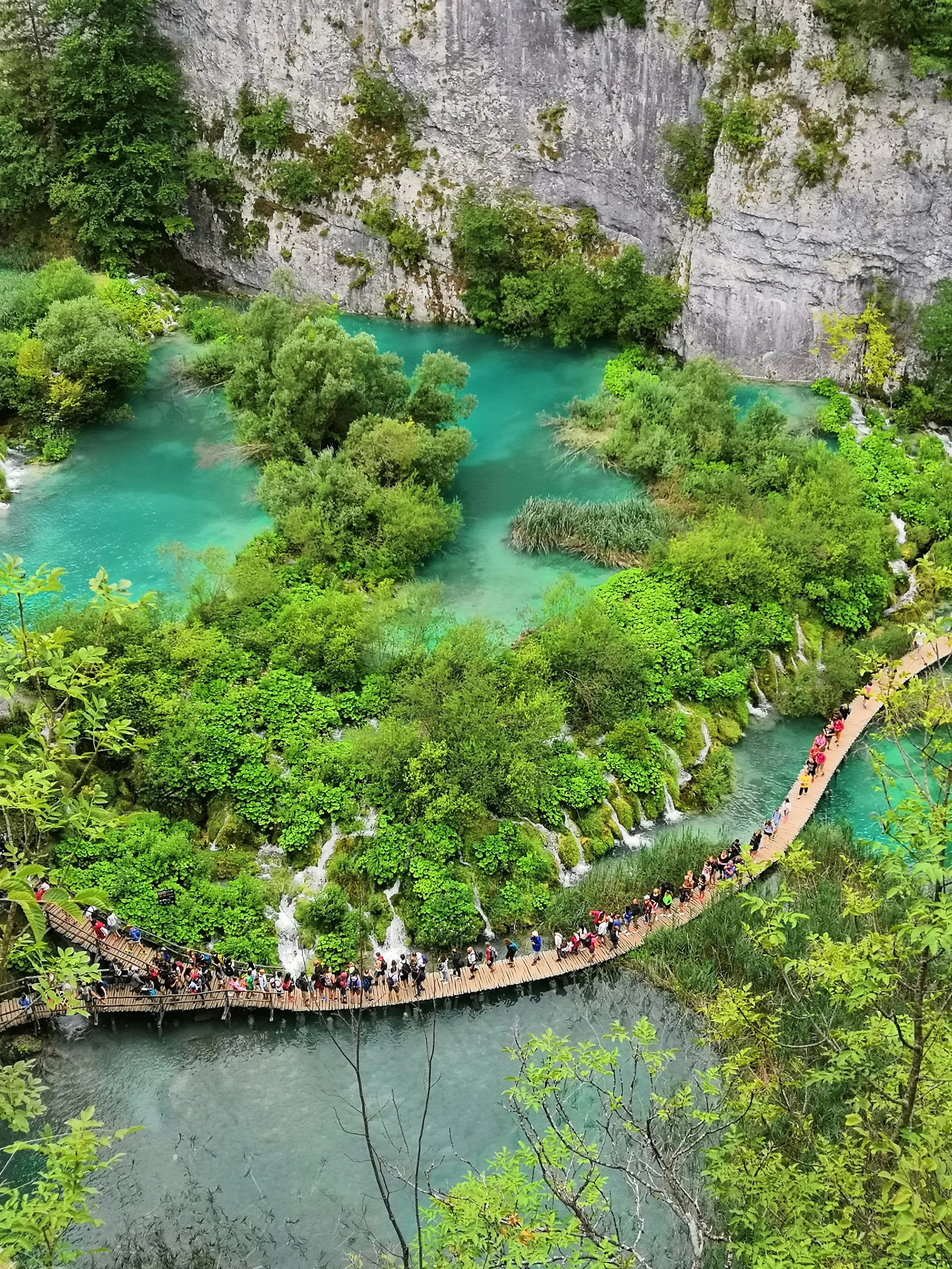 Plitvice Lakes National Park, known for turquoise lakes, cascading waterfalls, lush forests, and scenic wooden boardwalks in Croatia.
