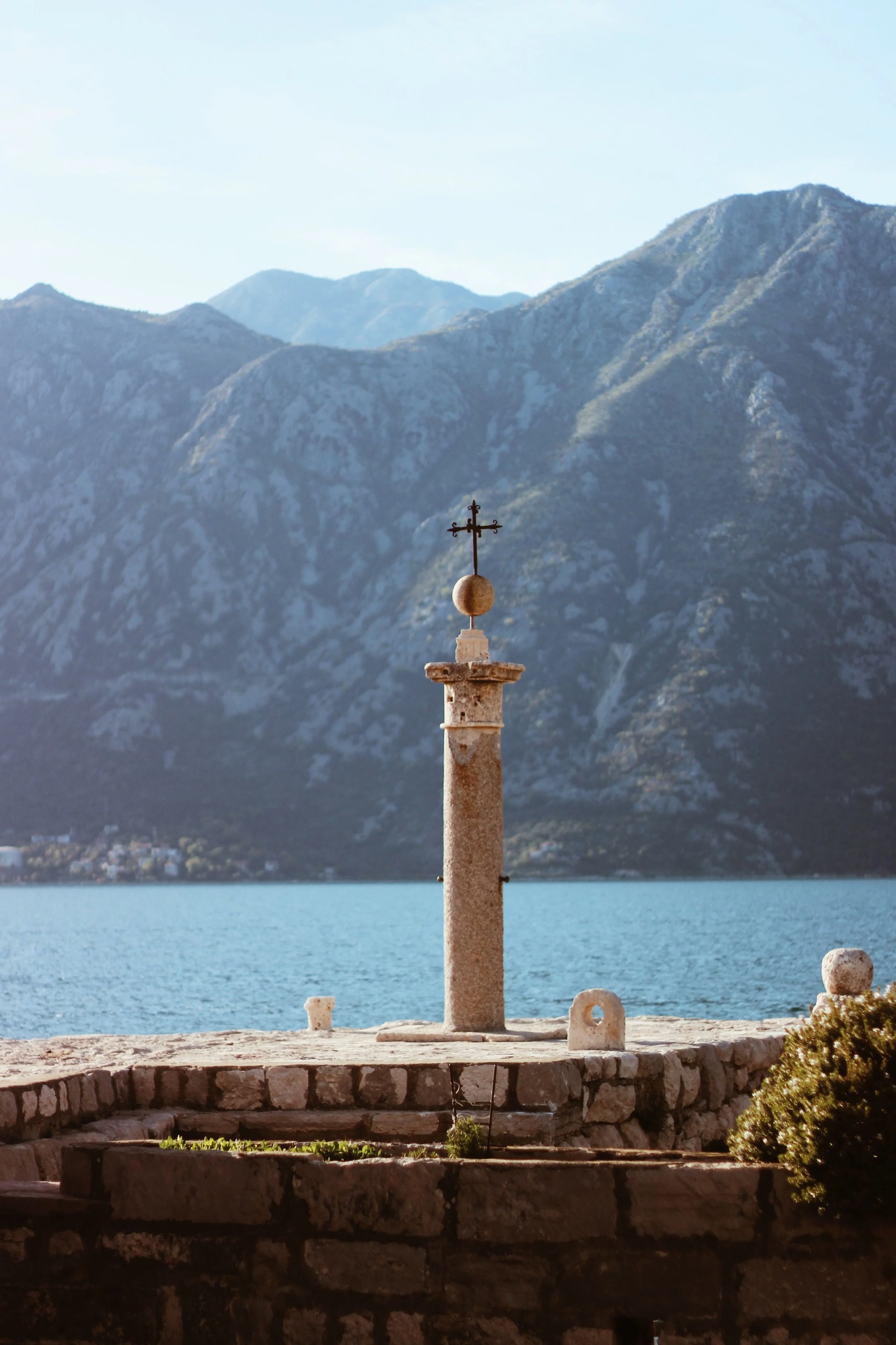 Cross monument overlooking the Bay of Kotor and surrounding mountains in Montenegro.