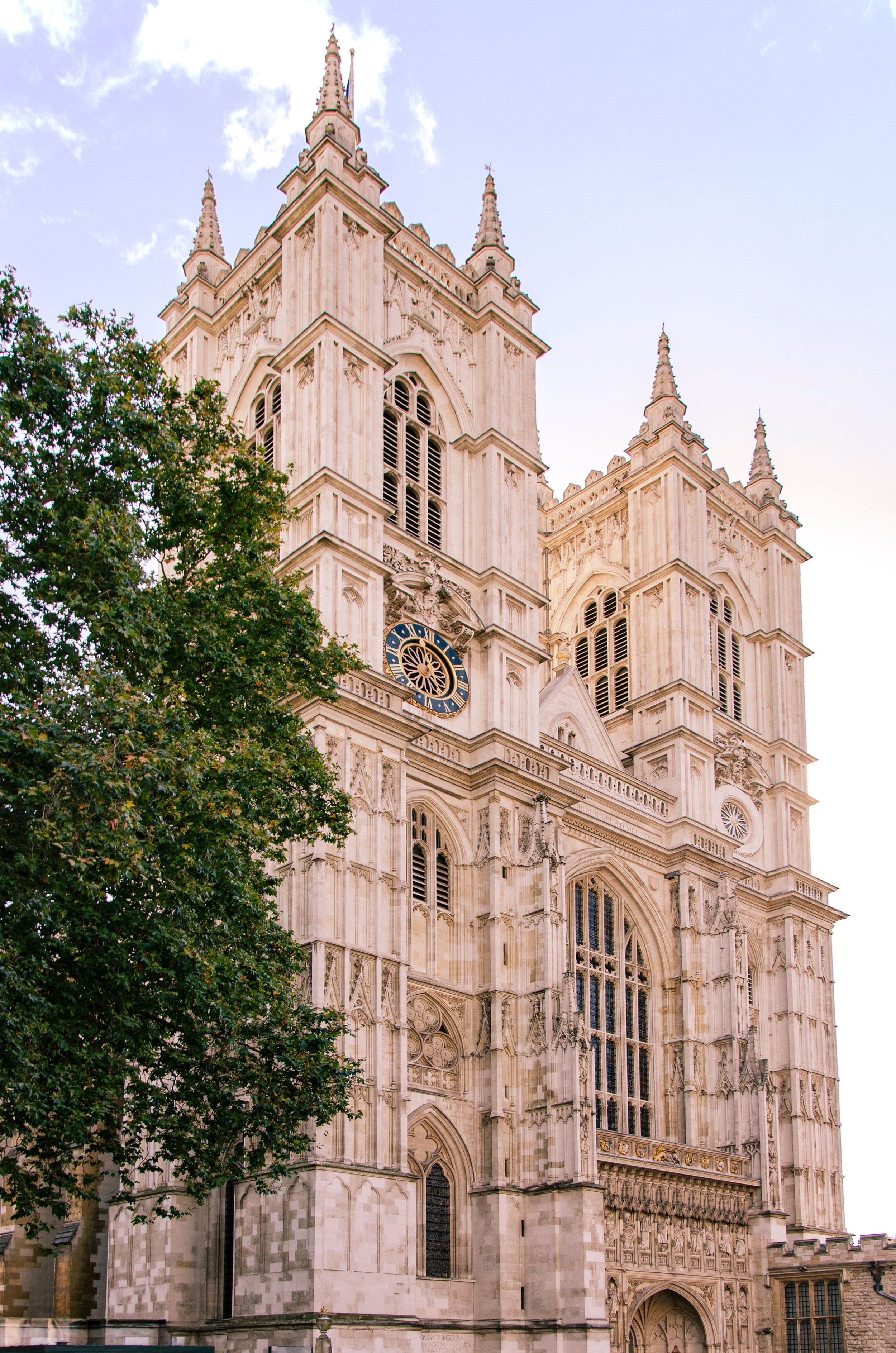 Westminster Abbey west front and towers from Parliament Square in afternoon light, London, England