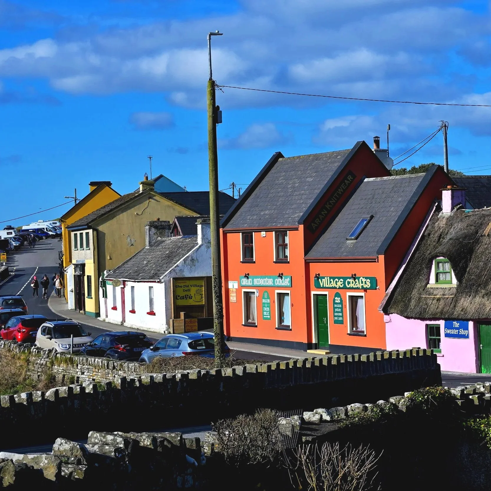 Doolin, County Clare, Ireland, a charming village known for its colorful buildings, traditional pubs, and lively streets.