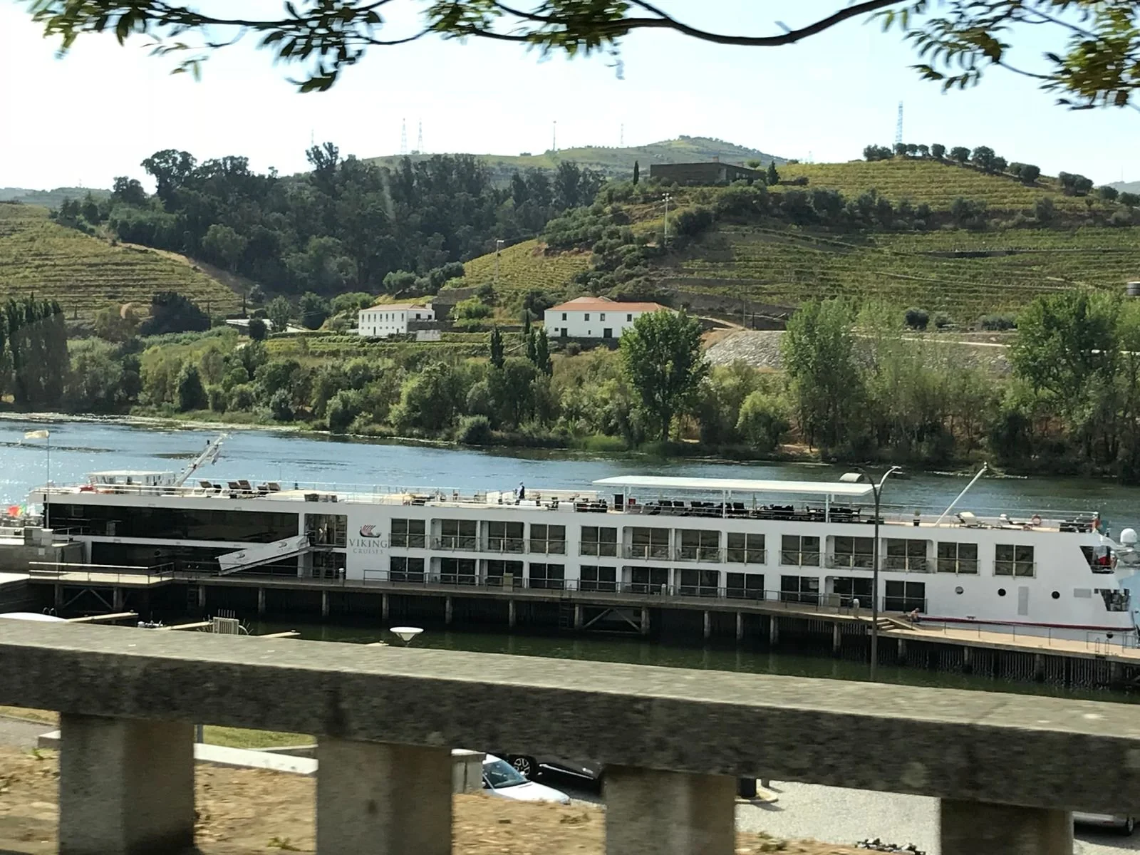 Scenic river cruise through Portugal’s Douro Valley, with views of terraced vineyards.