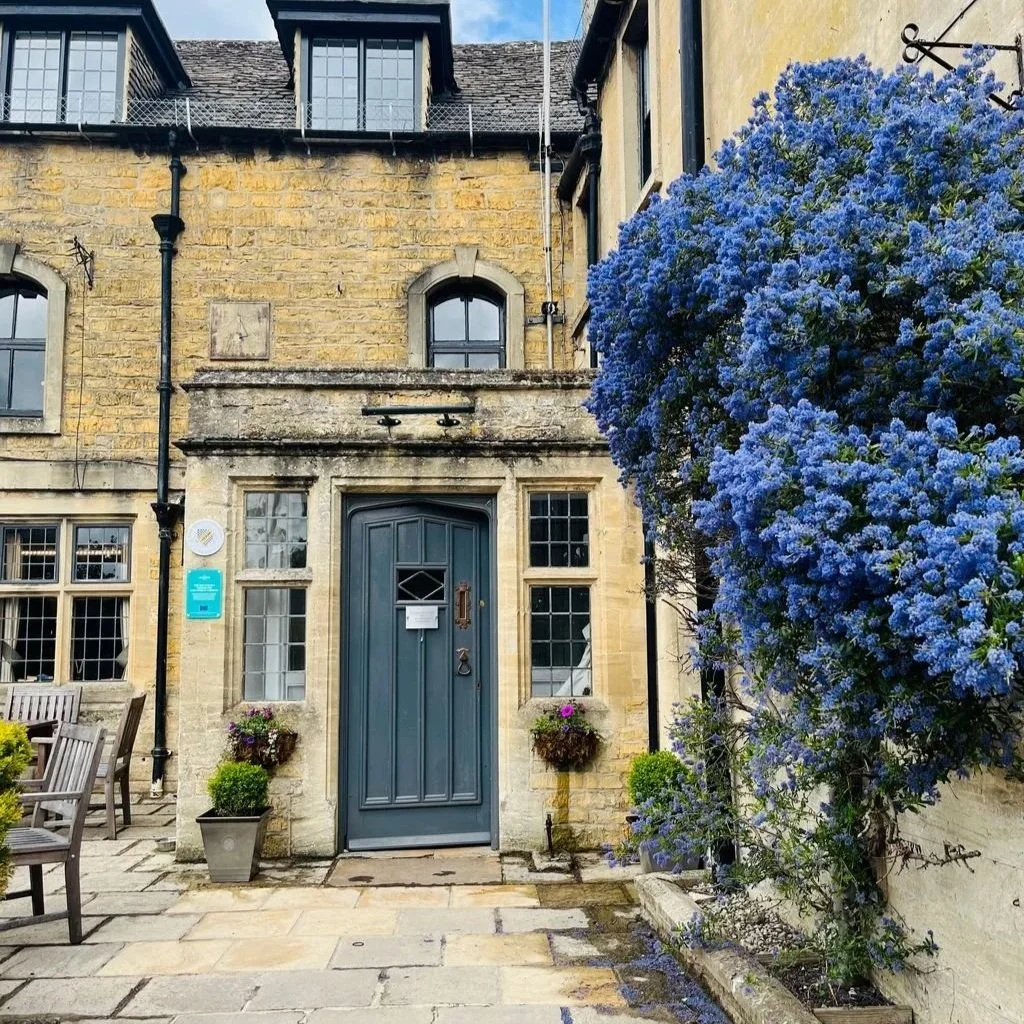 The Old New Inn, an 18th-century Grade II listed inn with traditional Cotswold stone architecture in Bourton-on-the-Water, England.