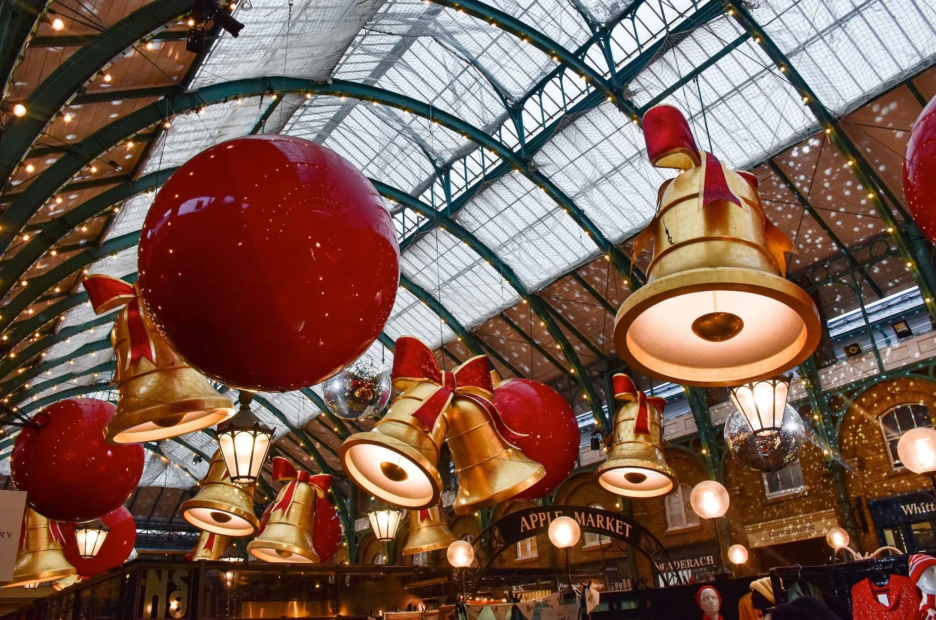 Christmas decorations at Covent Garden Market in London, featuring large ornaments and festive lights.