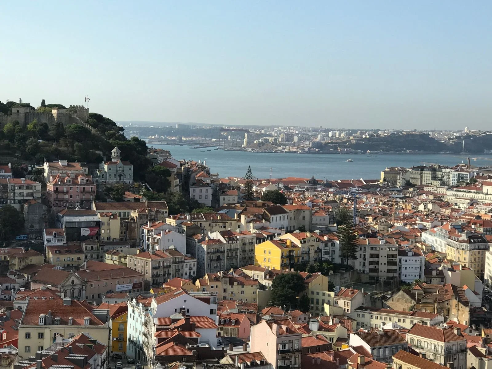 Lisbon, Portugal, featuring historic architecture, colorful buildings, and distinctive terracotta rooftops.