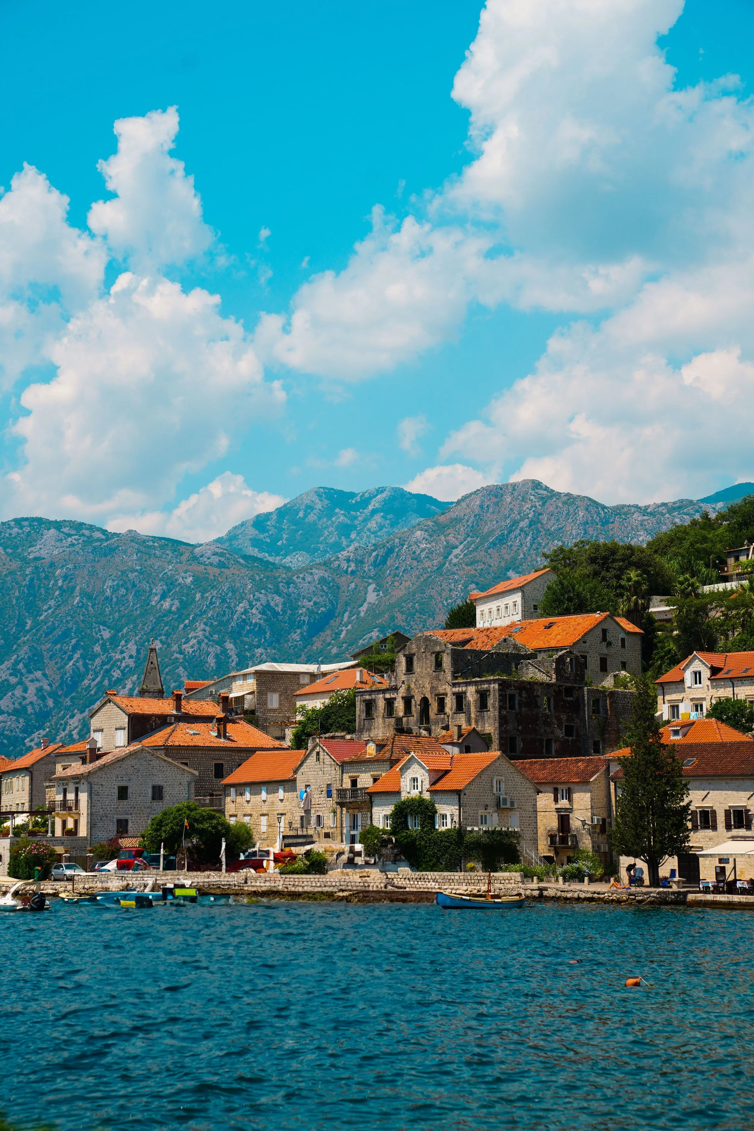 Perast, a historic coastal town on the Bay of Kotor, known for its Baroque stone buildings, waterfront, and dramatic limestone mountains in Montenegro.