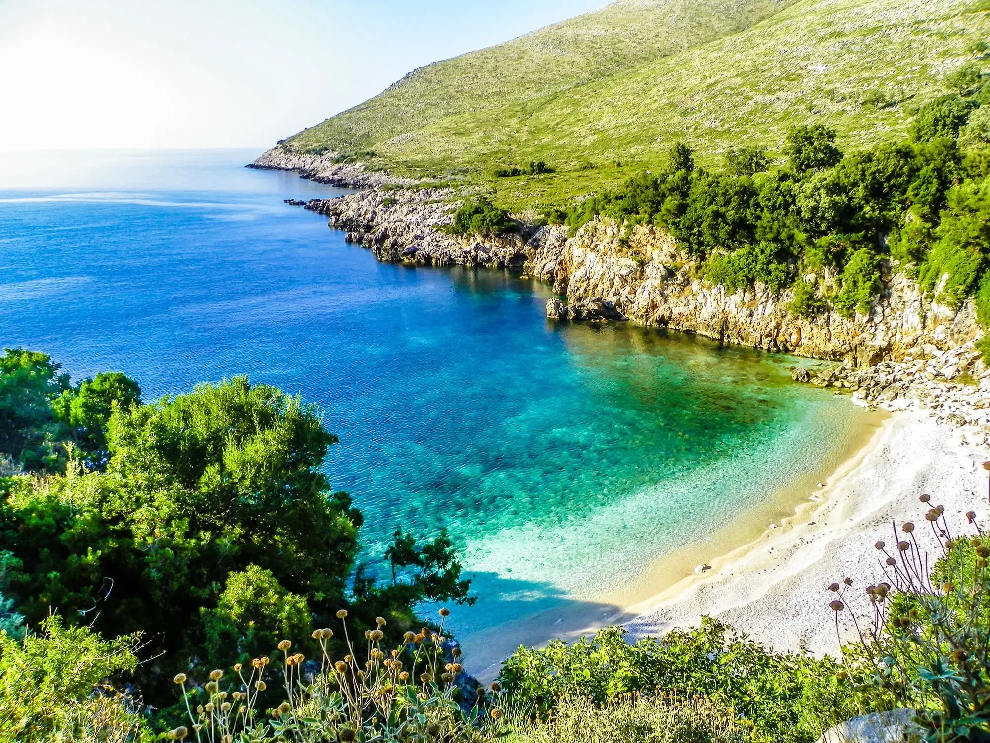 Karaburun Peninsula, Albania, featuring a rugged coastline and clear Ionian waters with a rich maritime history.