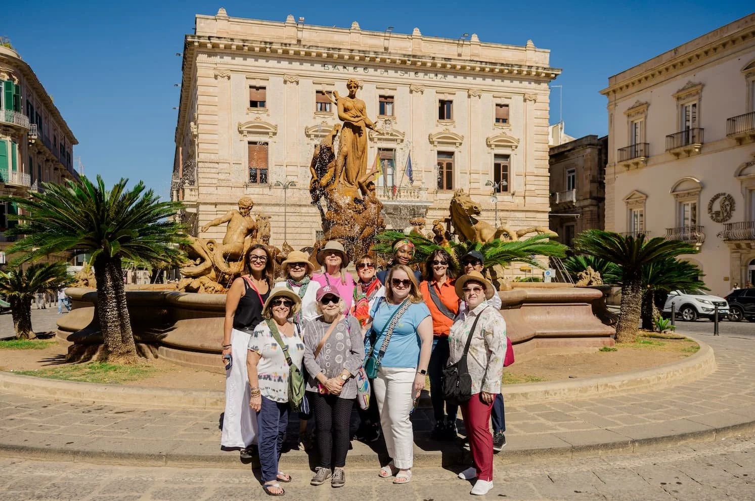 The Fontana di Diana in Piazza Archimede on Ortigia Island in Syracuse, Sicily, Italy, featuring an ornate fountain depicting the goddess Diana and figures from Greek mythology.
