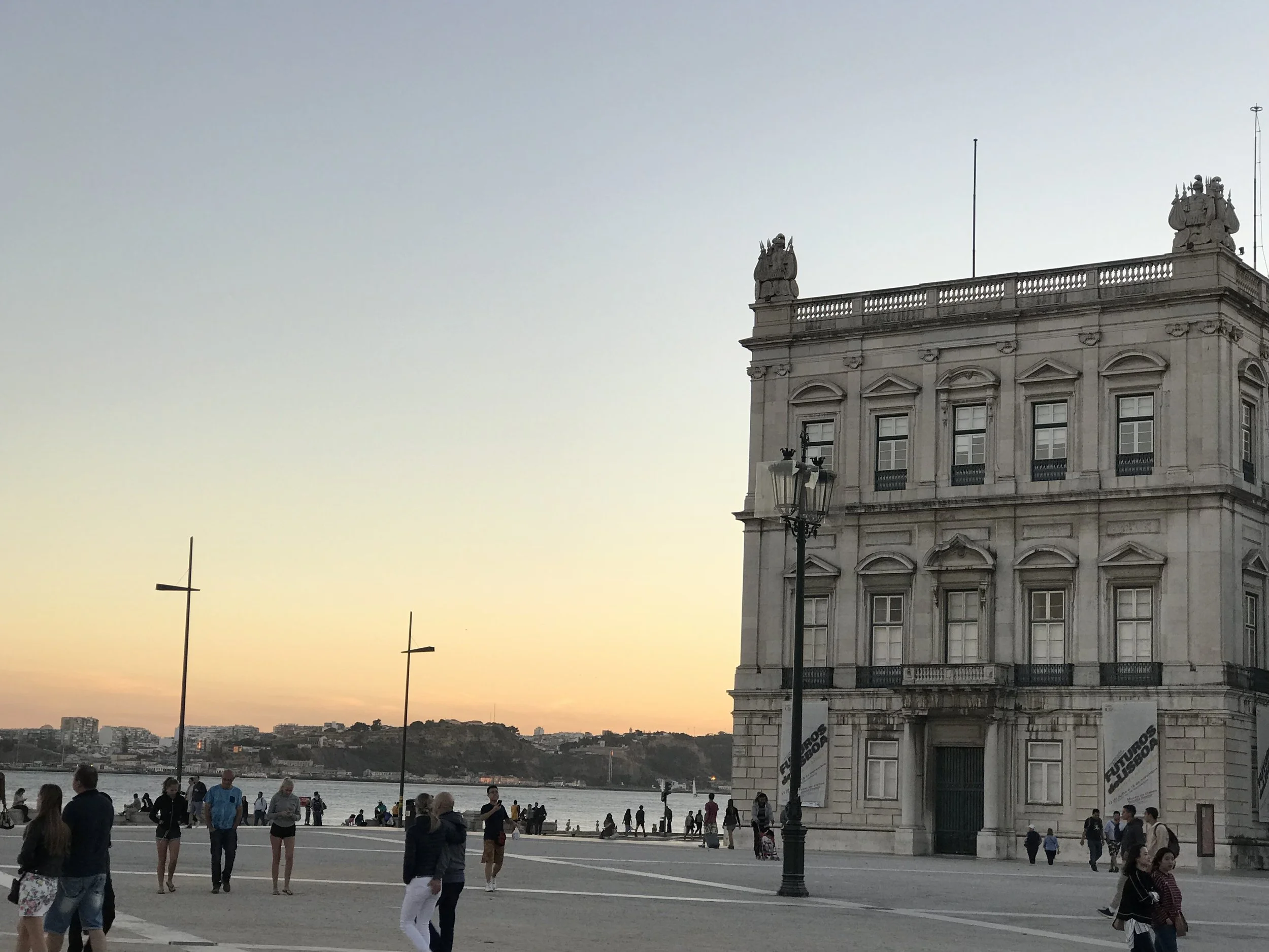 the symmetrical 18th-century neoclassical towers (the Western Tower, or Torreão Poente) framing the Praça do Comércio in Lisbon, Portugal.