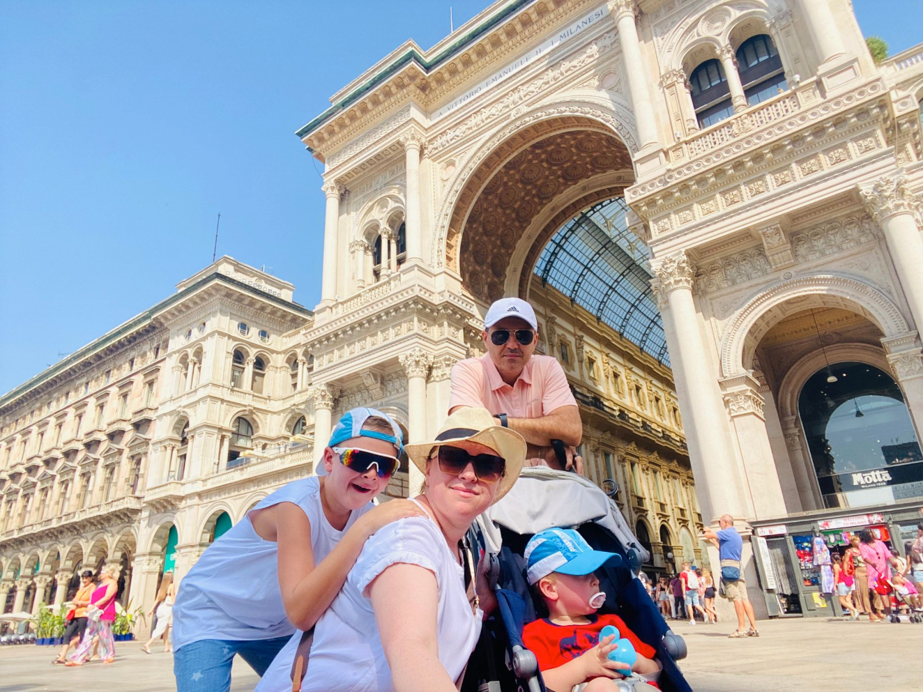 Galleria Vittorio Emanuele II in Milan, Italy, featuring elegant historic architecture, a grand glass-domed roof, and ornate interior arcades.