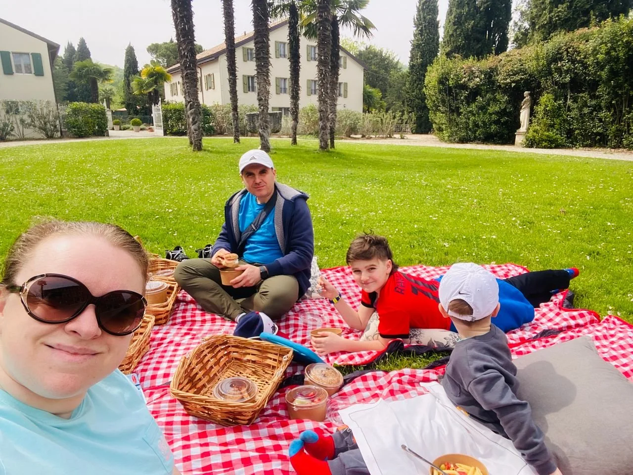 A family enjoying a picnic with the children in the beautiful Italian spring weather.