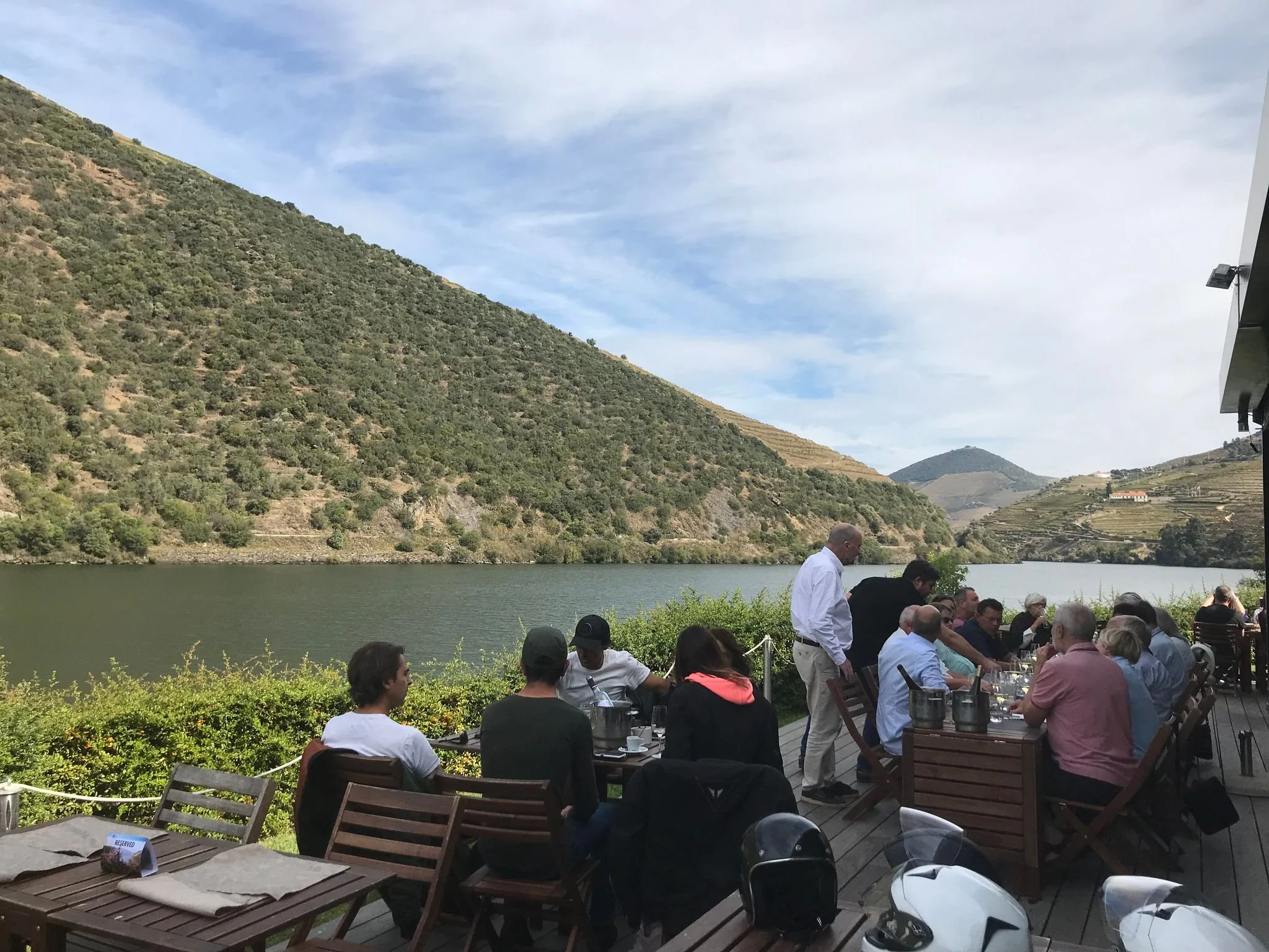Outdoor dining terrace overlooking the Douro River and terraced vineyards in the Douro Valley, Portugal.